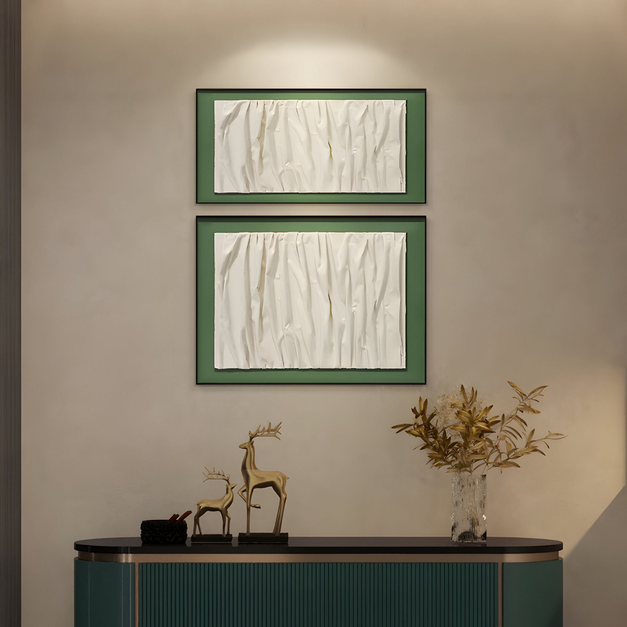 A modern interior showcases Giant Sculptures' Foldara Cream & Green Draped Paper Dual-Panel 3D Wall Art above a console table with gold deer figurines and a vase of golden foliage on a beige wall.
