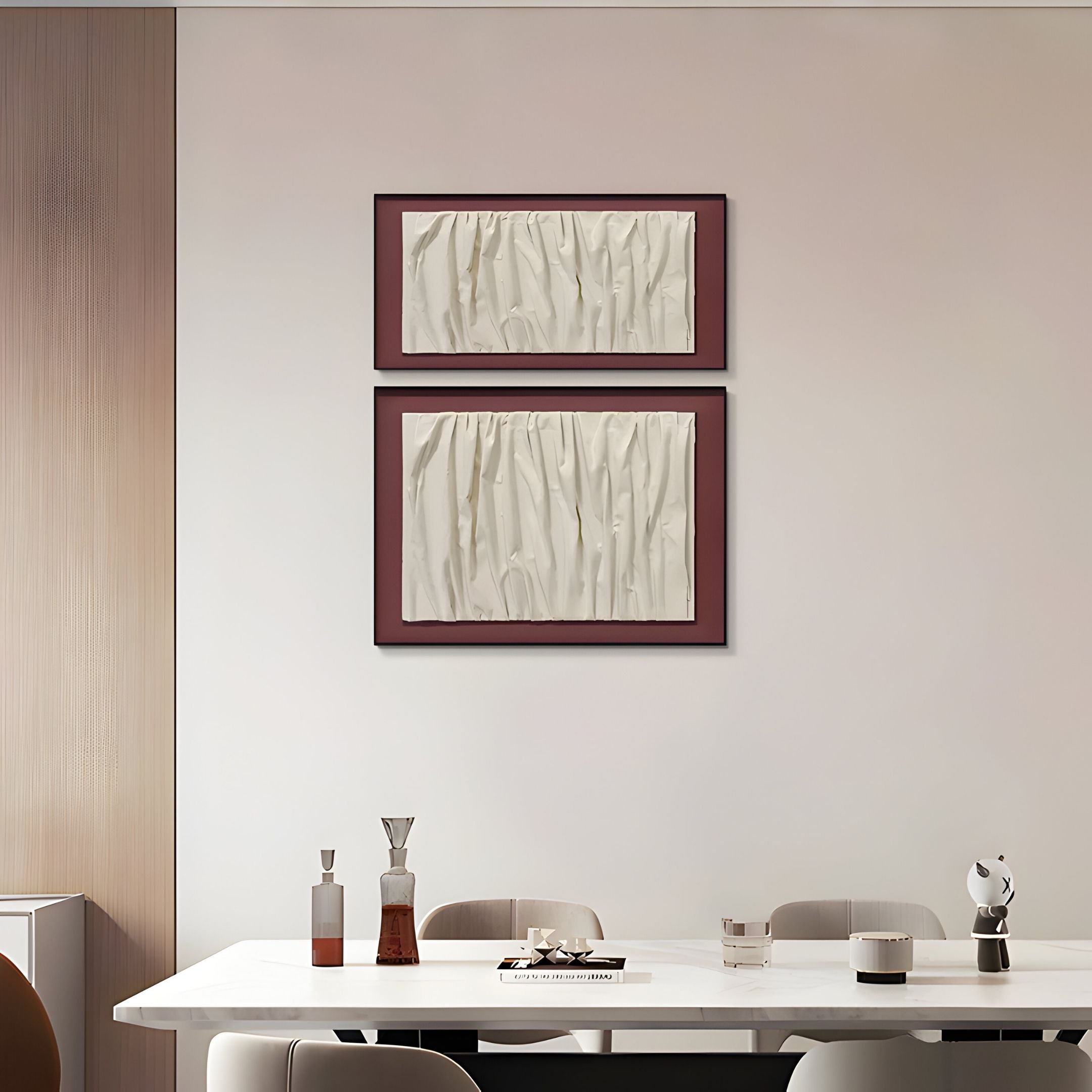 A modern dining room features a white table, contemporary chairs, and drinks, with Foldara Cream & Burgundy Draped Paper Dual-Panel 3D Wall Art by Giant Sculptures adding subtle wabi-sabi decor above the table.