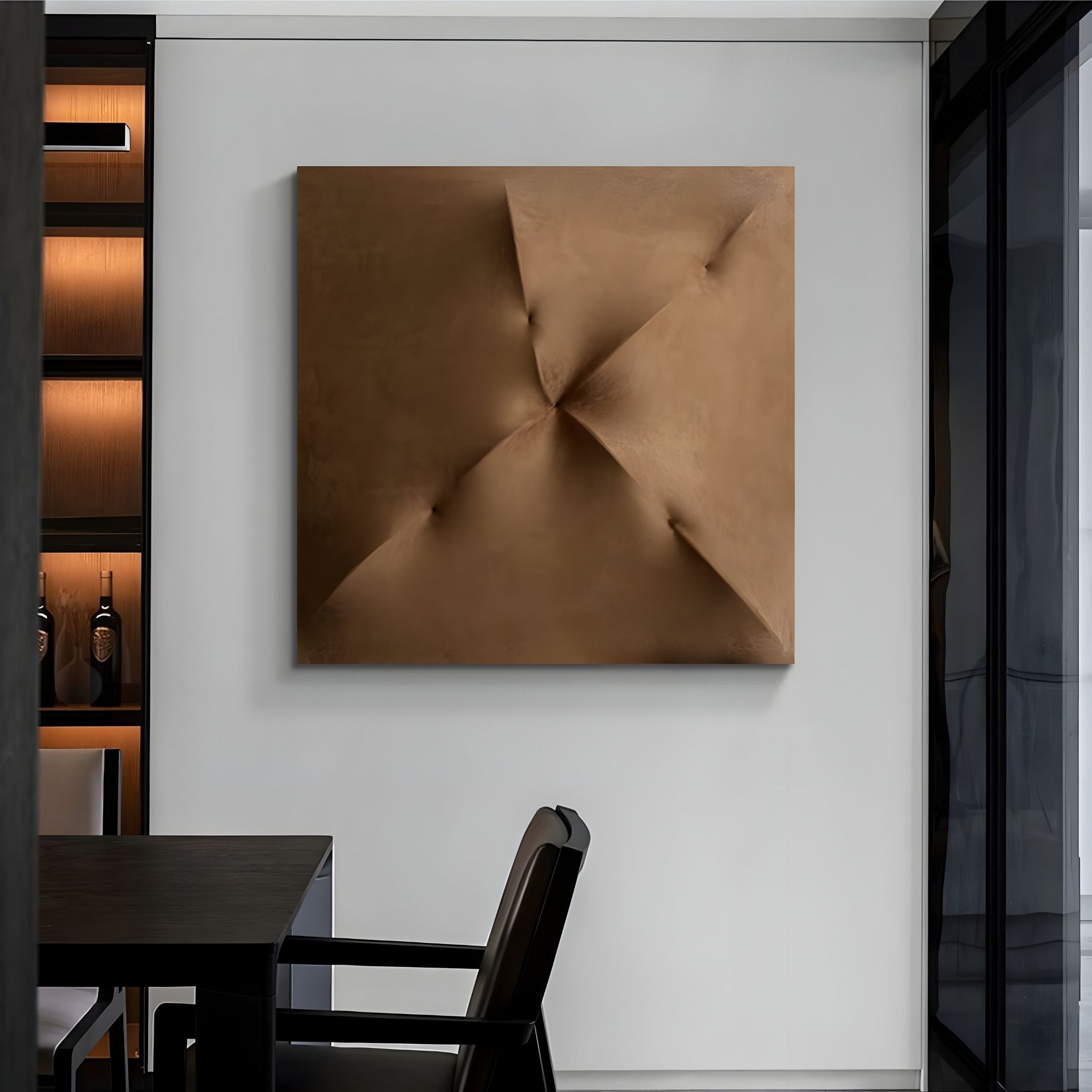 A minimalist office with a black desk and chair, dark bottle-filled shelves, and Giant Sculptures' Veylora Umber Folded Texture Fabric 3D Wall Art featuring a geometric design on a white wall.