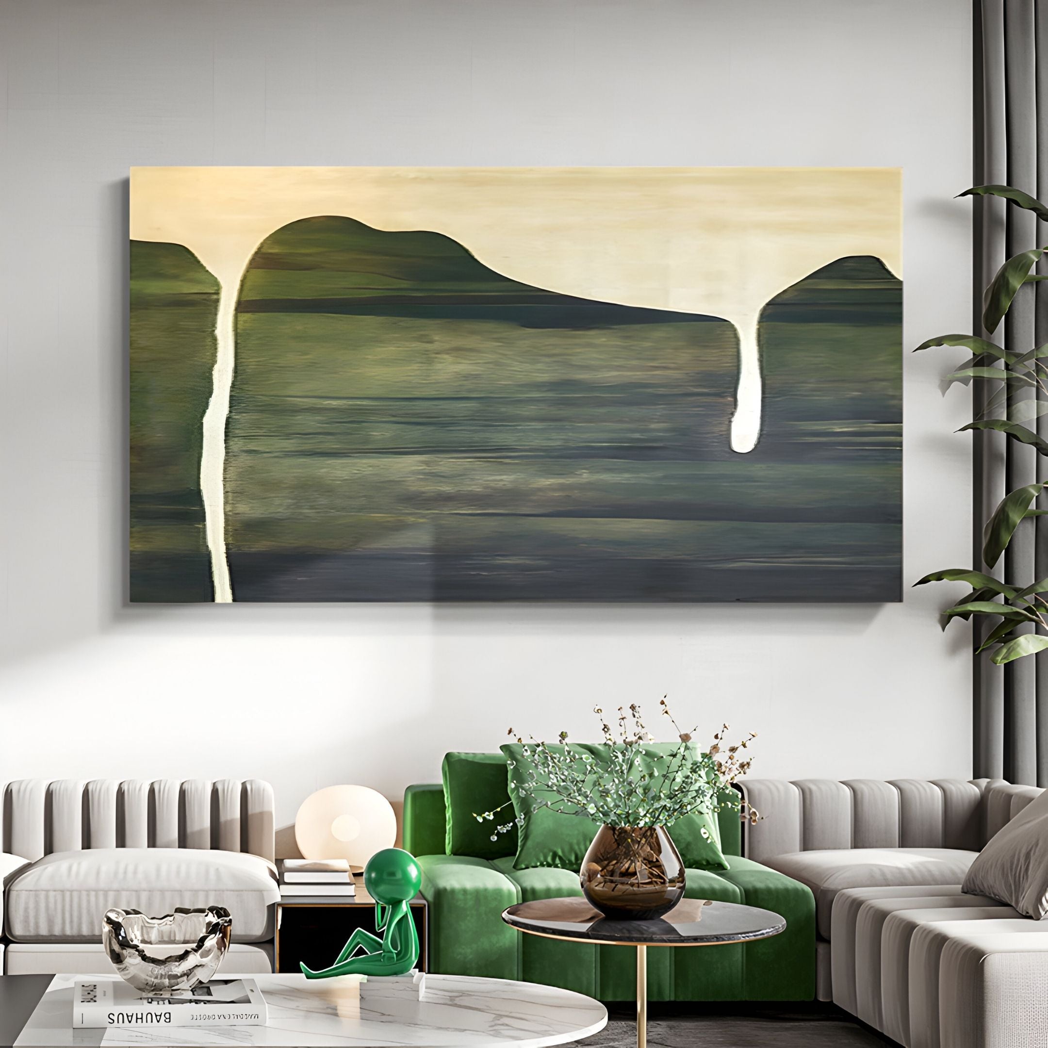 A modern living room showcases the Seralyon Green Drip Peak Wide Canvas Wall Art by Giant Sculptures—a large abstract piece with green and yellow tones and white drips above a green couch, gray sofas, a round coffee table, and accents.