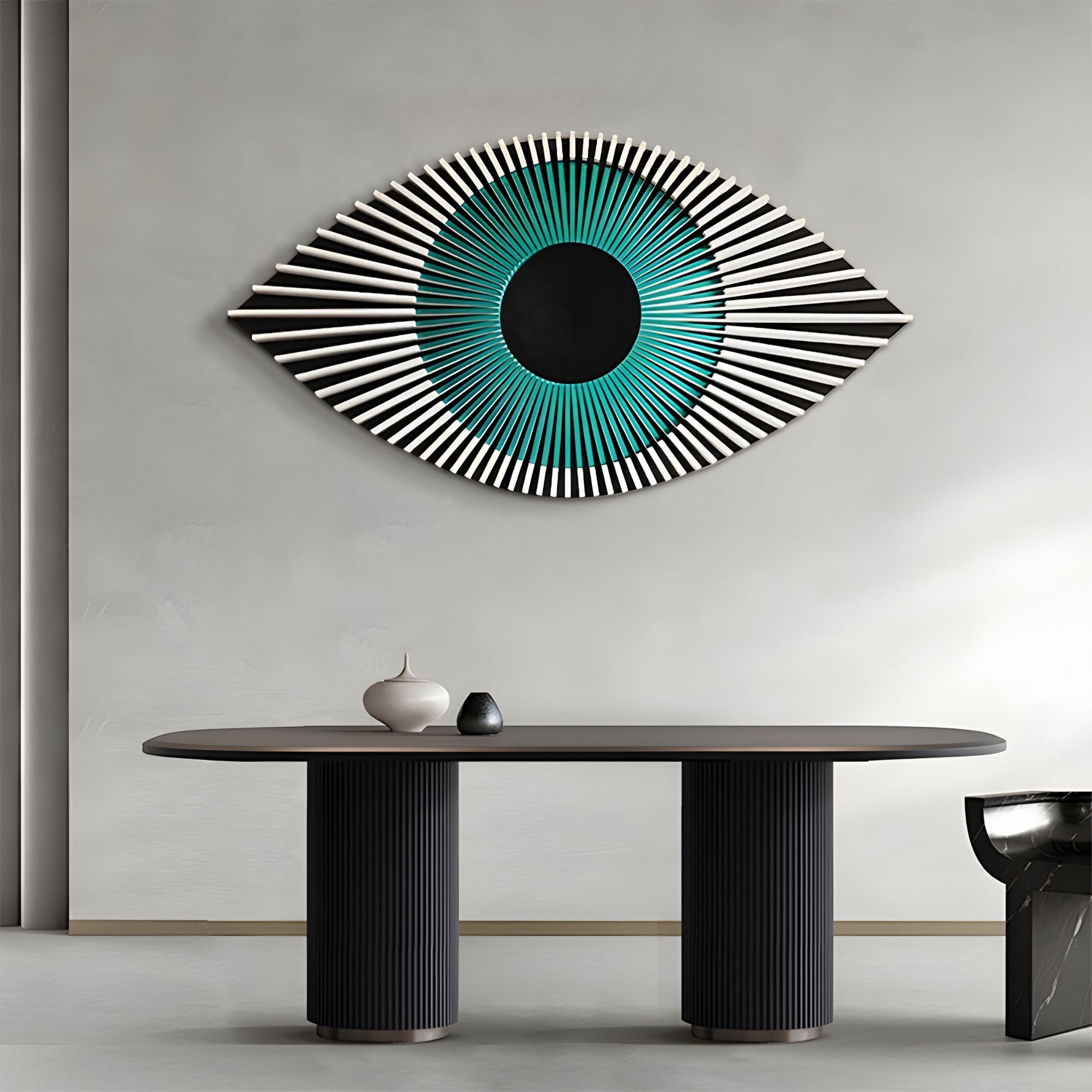 A modern, minimalist room features the Aurevion Teal Radiant Eye 3D Wall Art by Giant Sculptures, showcasing teal and black concentric circles above a sleek oval table with a ribbed base, two small vases, and a black chair to the right.