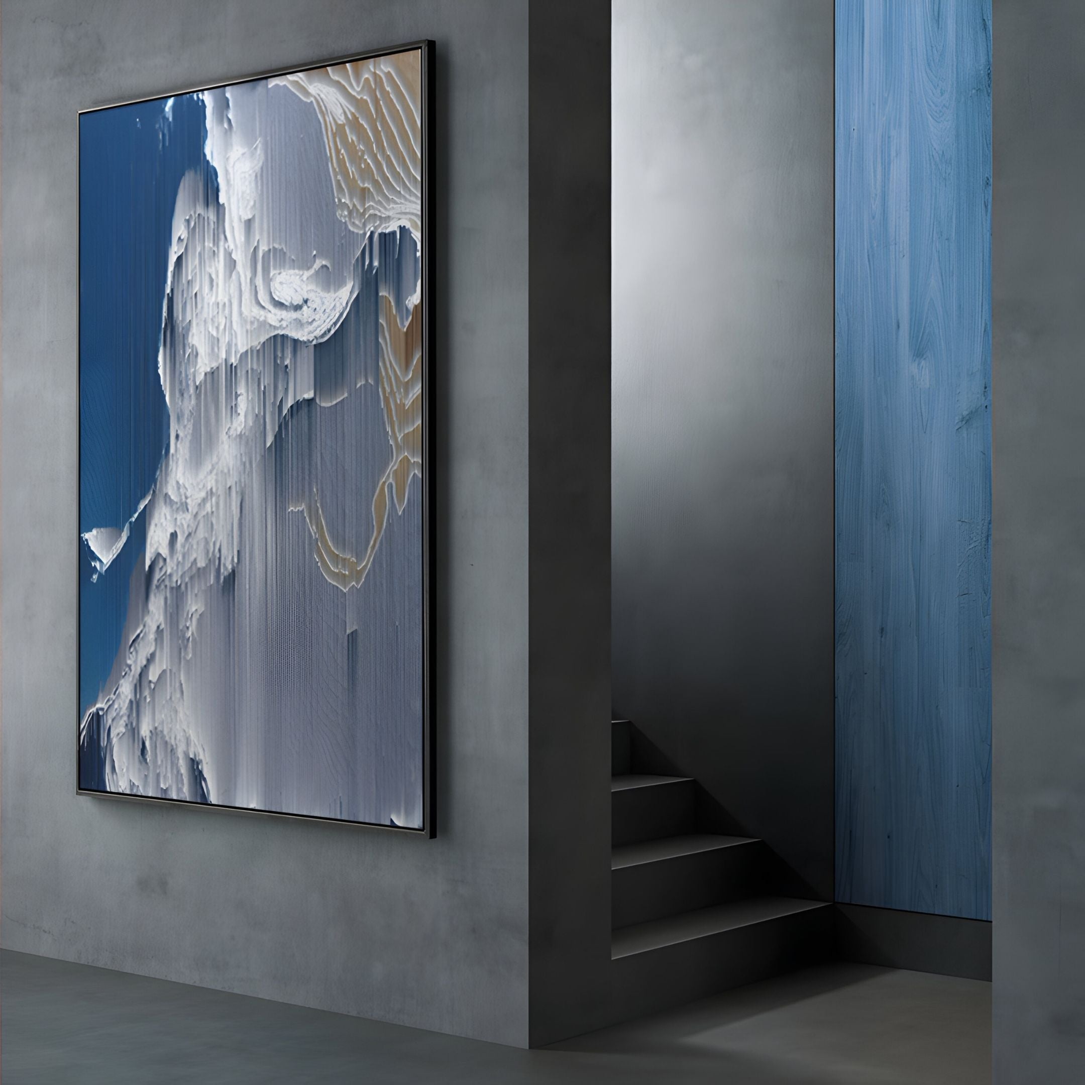 The Aerolune Blue & White Vertical Gradient Rope 3D Wall Art by Giant Sculptures hangs on a gray wall next to a modern staircase and a vertical blue wood panel, showcasing flowing textures in blue and white.
