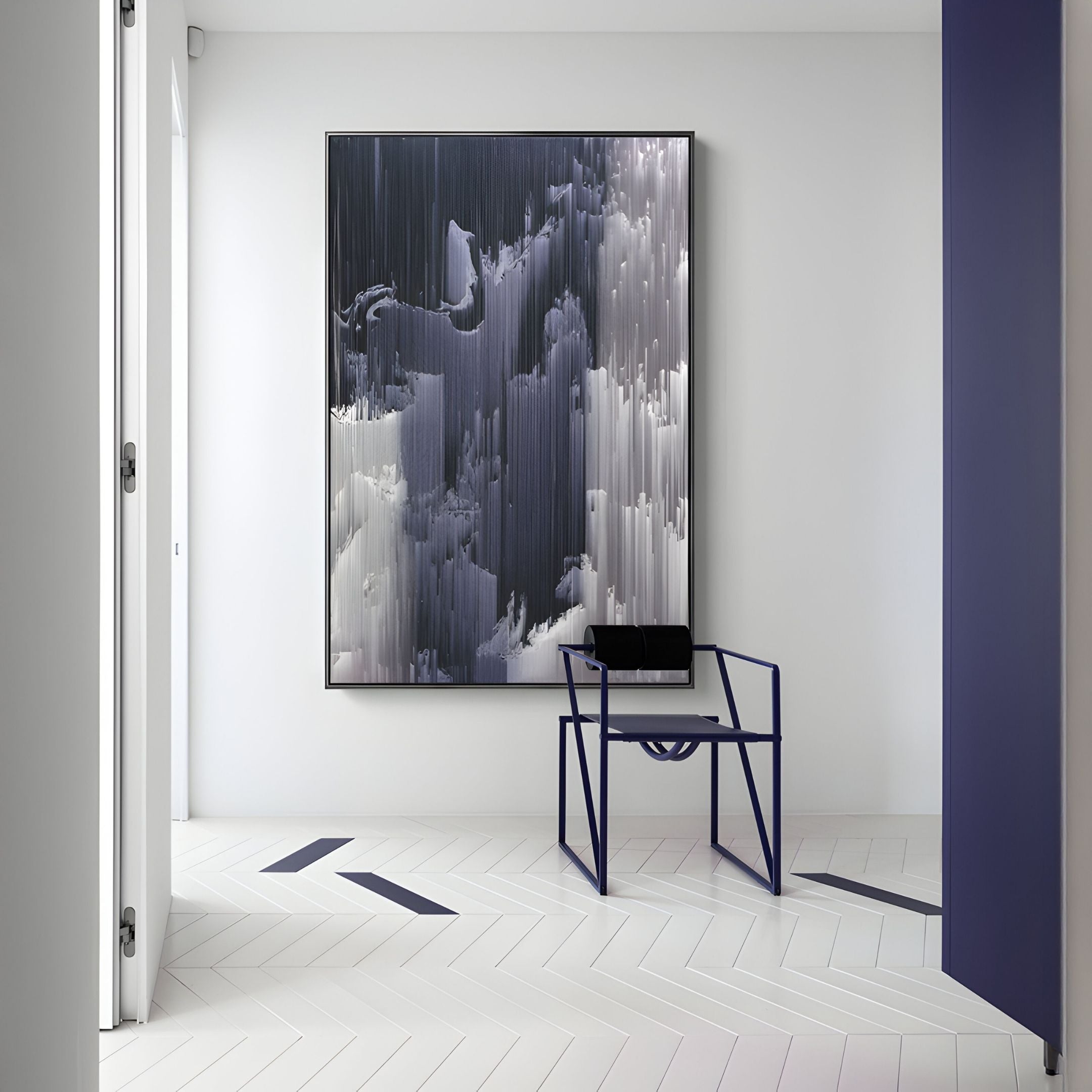 Minimalist room with a white herringbone floor, modern navy chair, and Giant Sculptures' Aerolune Grey & Silver Vertical Drift Rope 3D Wall Art featuring black, white, and gray vertical brushstrokes on a crisp white wall.