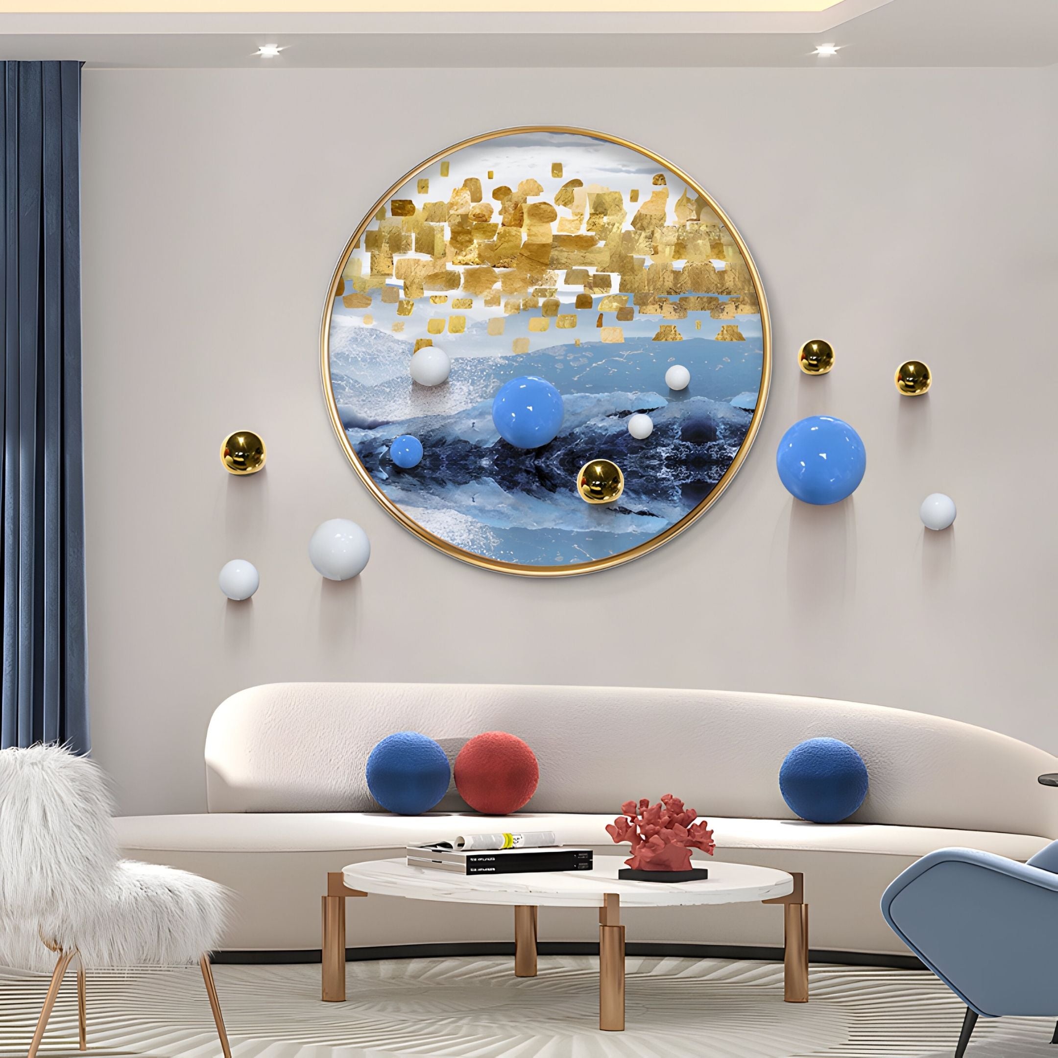 A modern living room features the Aurellune Blue & Gold Horizon 3D Wall Art With Metal Balls by Giant Sculptures above a curved white sofa. Decorative spheres and a coral sculpture on a white coffee table complete the look.