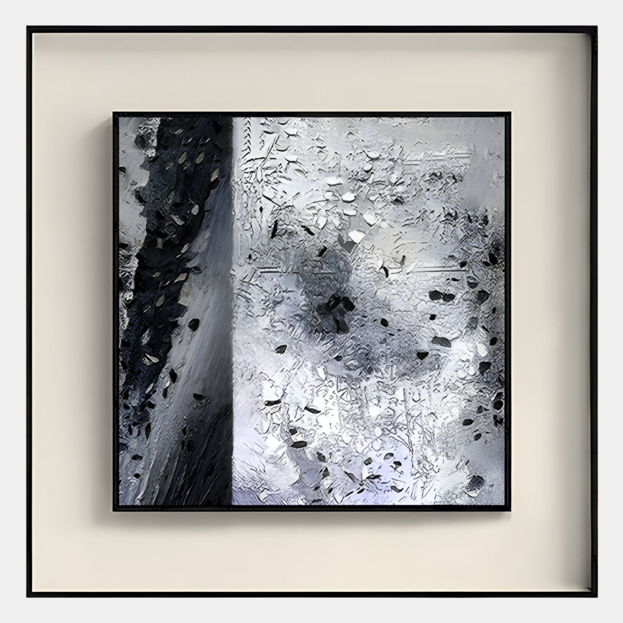 The Stratonis Grey Terrain Textured Framed Wall Art by Giant Sculptures features black, gray, and white abstract patterns with dark fragments and varied surfaces, set in a sleek black frame against a pale background.