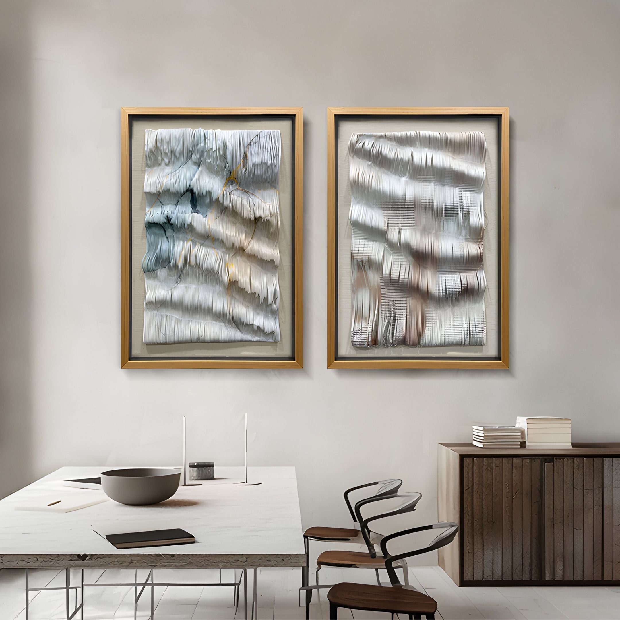A modern dining room with a minimalist table, four chairs, and two Giant Sculptures Linscario Mistfold White & Blue Ripple Texture 3D Wall Art pieces framed and hung side by side—ideal for luxury interiors.