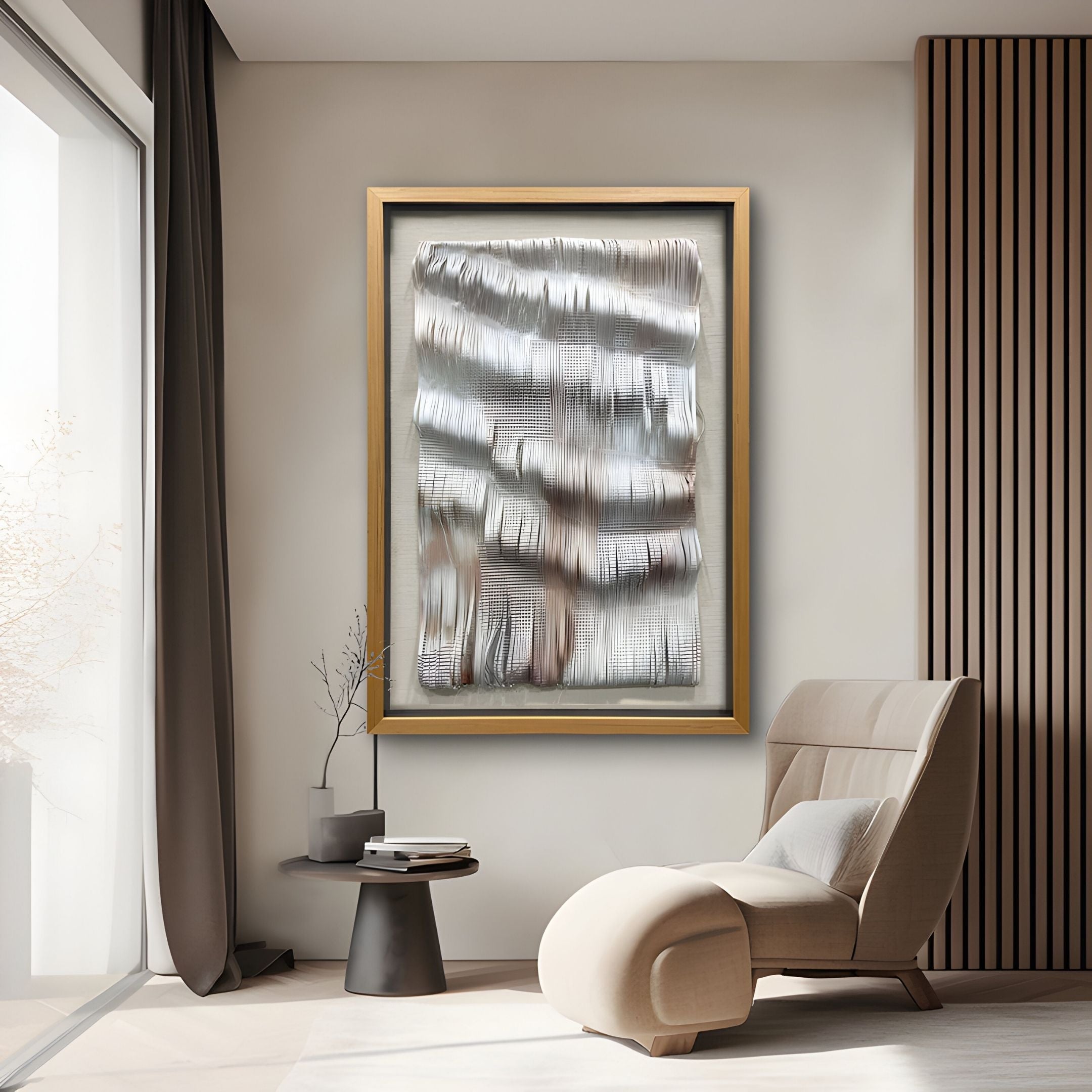 A modern living room features a beige lounge chair, side table, and the Linscario Chrome Weave Ripple Texture 3D Wall Art by Giant Sculptures in a gold frame. Sunlight through sheer curtains enhances the elegance of this luxury space.