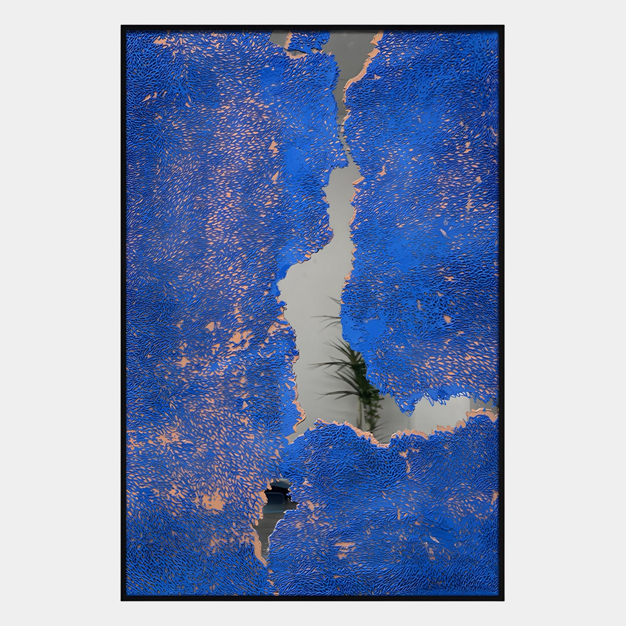 The Cerulex Blue Rift Textured Steel Mirror 3D Wall Art by Giant Sculptures features vivid blue and copper textures framing a reflective steel-like center, subtly revealing hints of plants and room elements in the background.