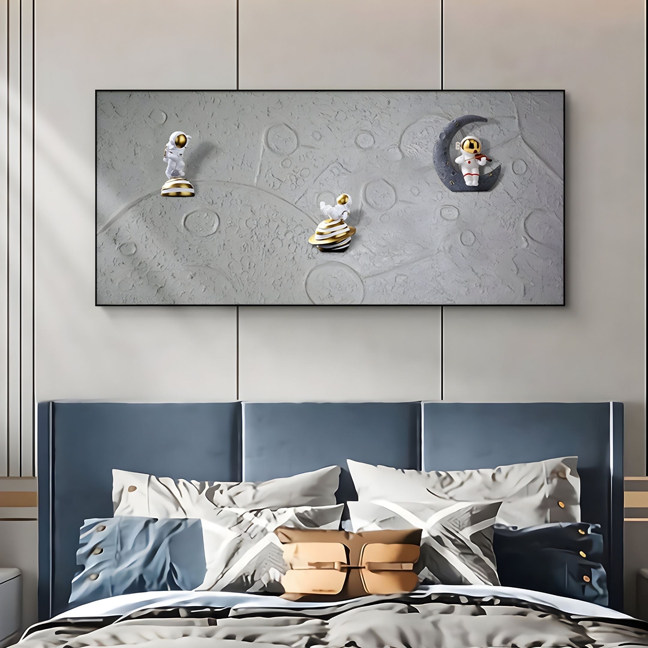 A modern bedroom with a blue padded headboard and geometric bedding features the Astravera Moon Patrol Gold Accents Astronaut 3D Wall Art by Giant Sculptures above the bed—perfect children's decor with 3D astronauts on a moon-like surface.