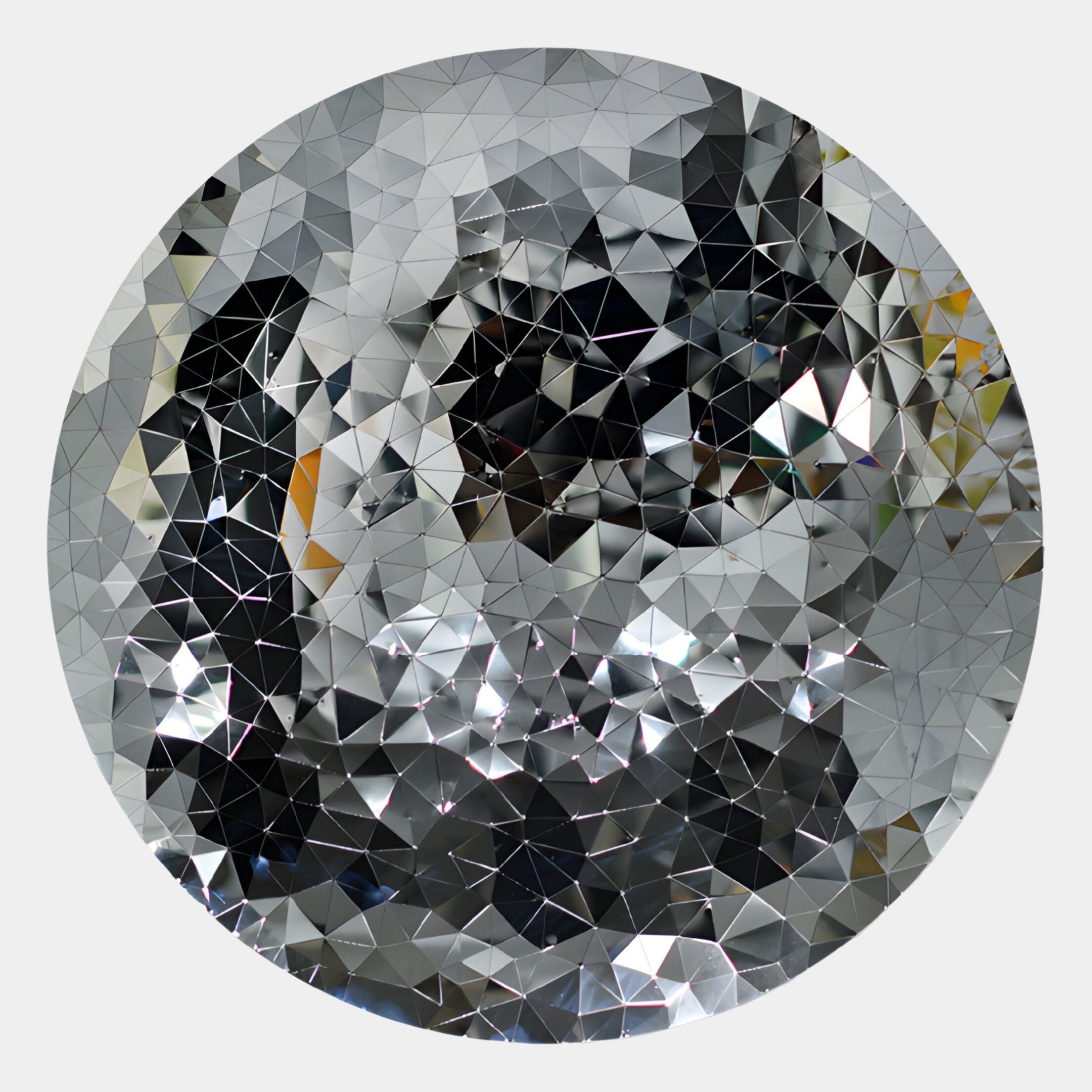 The Lumineris Silver Facet Matrix Circular Metal 3D Wall Art by Giant Sculptures features mirrored triangular facets in a geometric pattern, creating striking sculptural decor that distorts and scatters light.