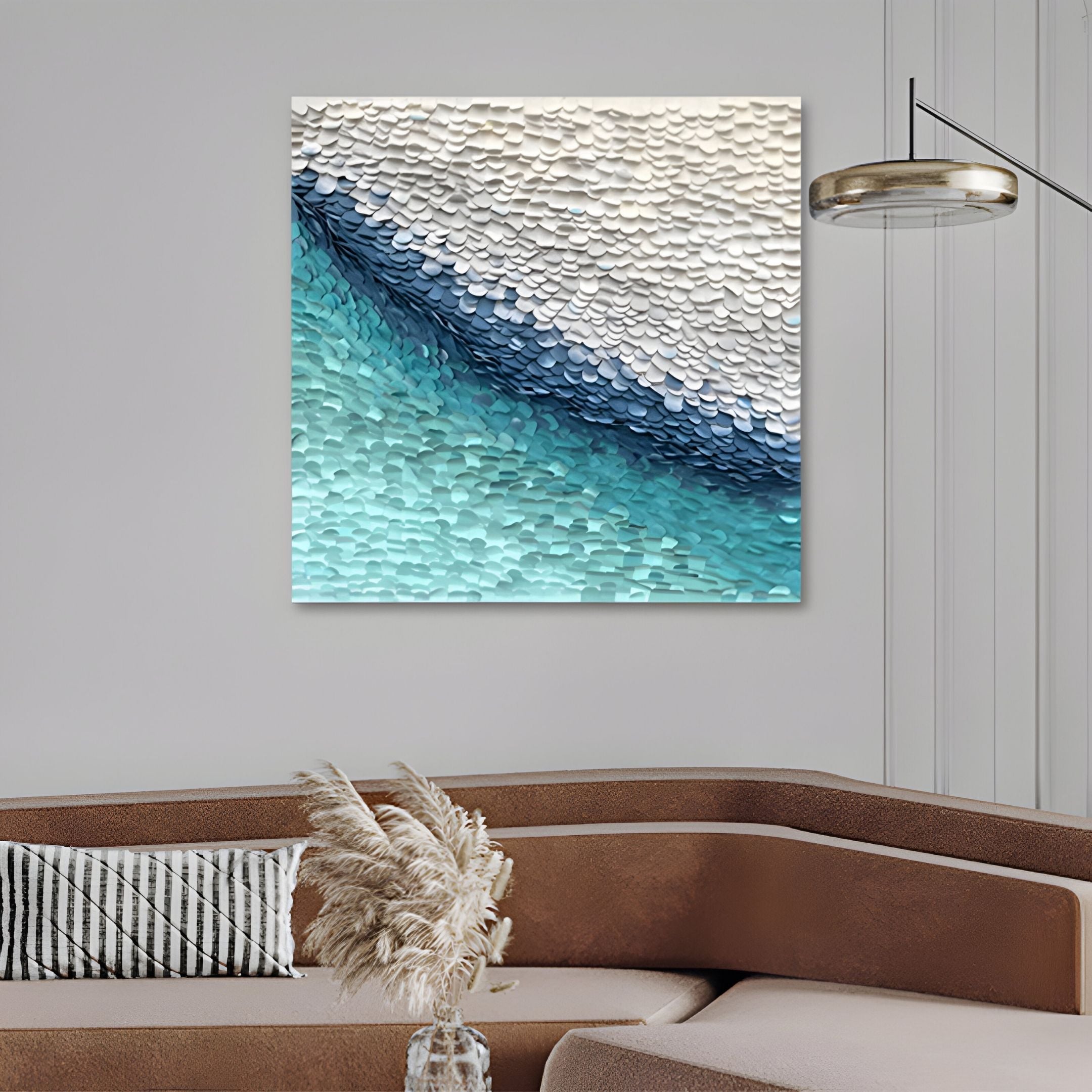 A modern living room with a brown sectional sofa, striped pillow, and pampas grass. Above the sofa hangs the Seravelle Aqua Blue Gradient Layered 3D Paper Wall Art by Giant Sculptures for a textured, abstract touch in blue, white, and gray.
