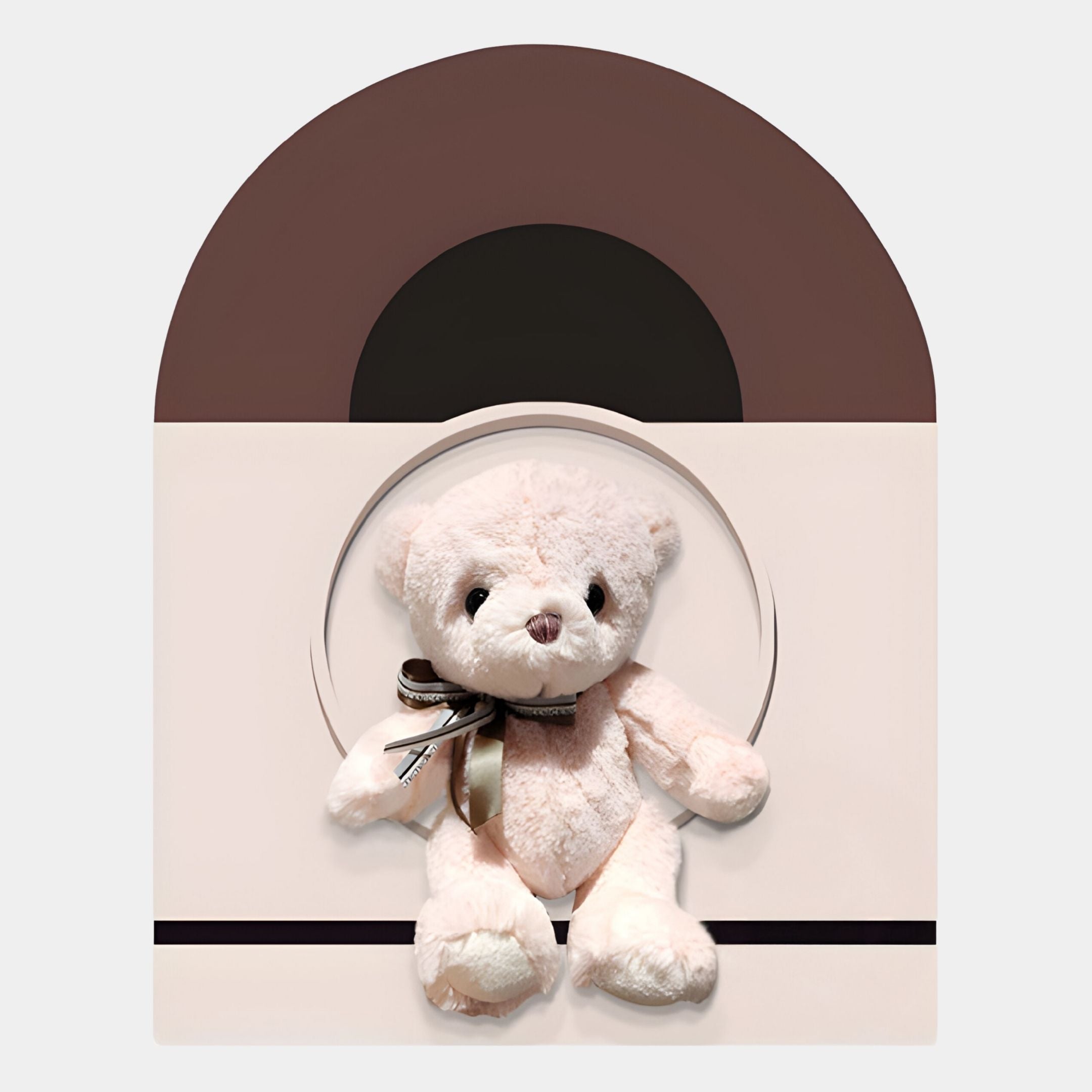 The Cuddiloft Blush Bear Plush Display 3D Wall Art by Giant Sculptures features a soft blush bear with a brown and cream ribbon, set before a circular cutout on a beige and brown geometric background—ideal for cozy nursery decor.