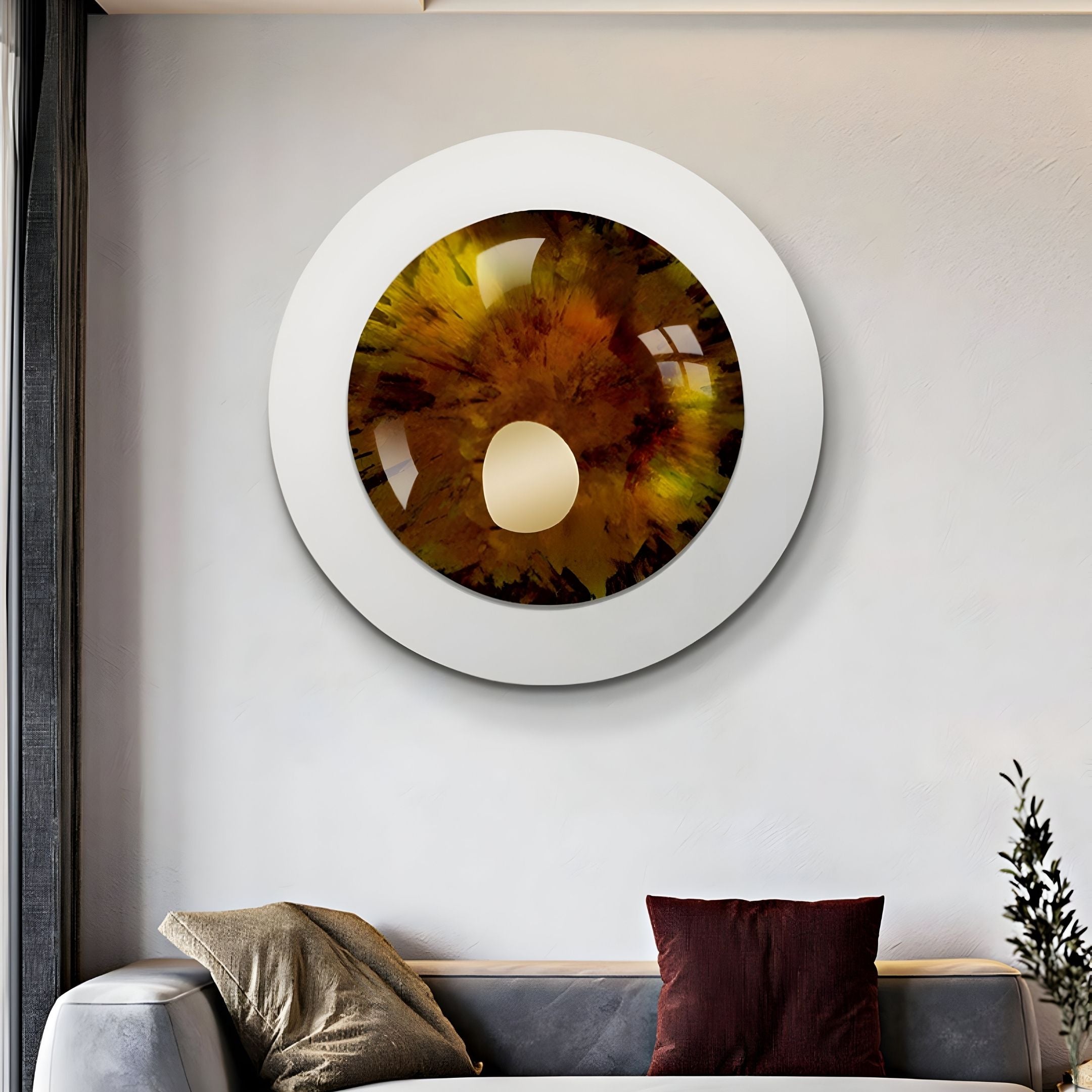 The Iriselle Amber Crystal Porcelain Round 3D Wall Art by Giant Sculptures, featuring brown, gold, and black tones, hangs above a gray sofa with beige and dark red cushions in a modern living room.