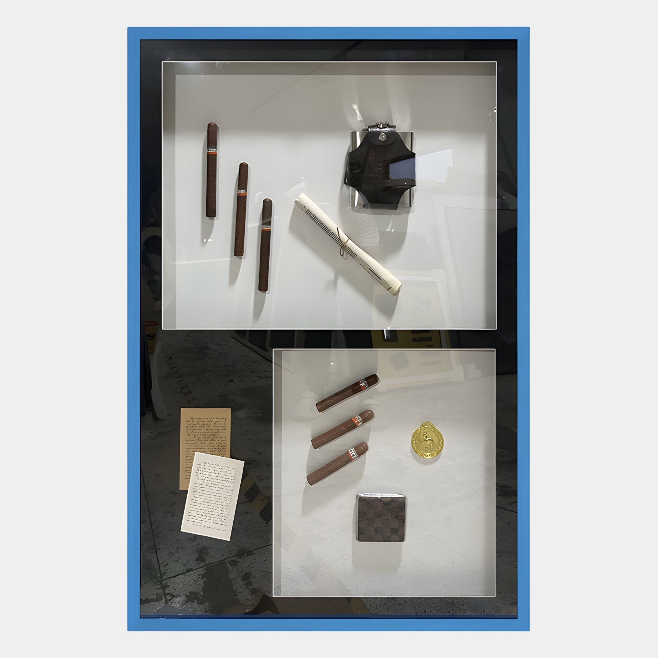 The Valet Noir Gentleman Cigar Gallery Box Framed Wall Art by Giant Sculptures features two sections with cigars, accessories, and luxury details—ideal for sophisticated decor. White background, blue border.
