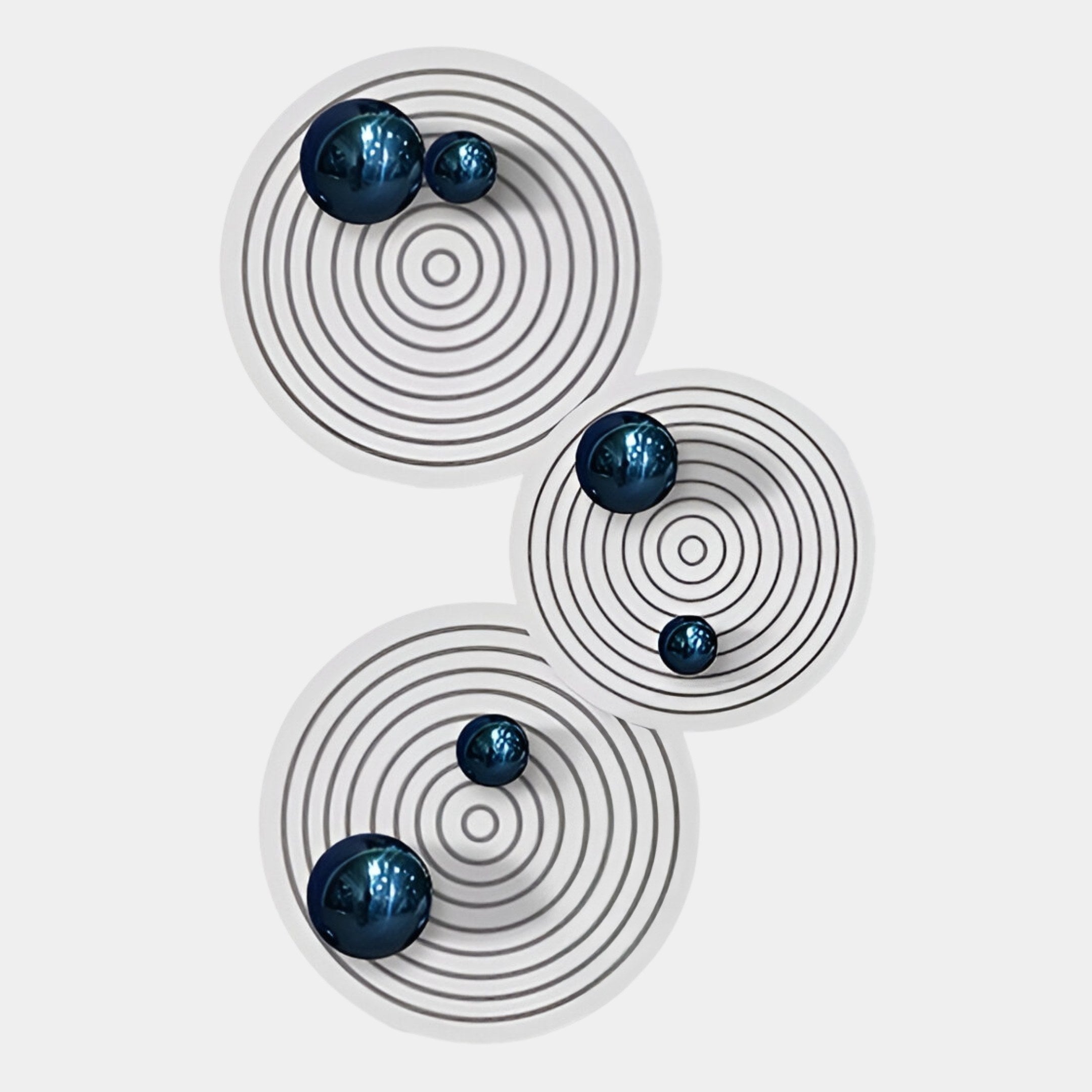 The Orbiora Blue Orb 3-Panel Concentric Sphere 3D Wall Art by Giant Sculptures features black concentric circles with reflective blue orbs on white panels, adding bold modern style to any interior space.