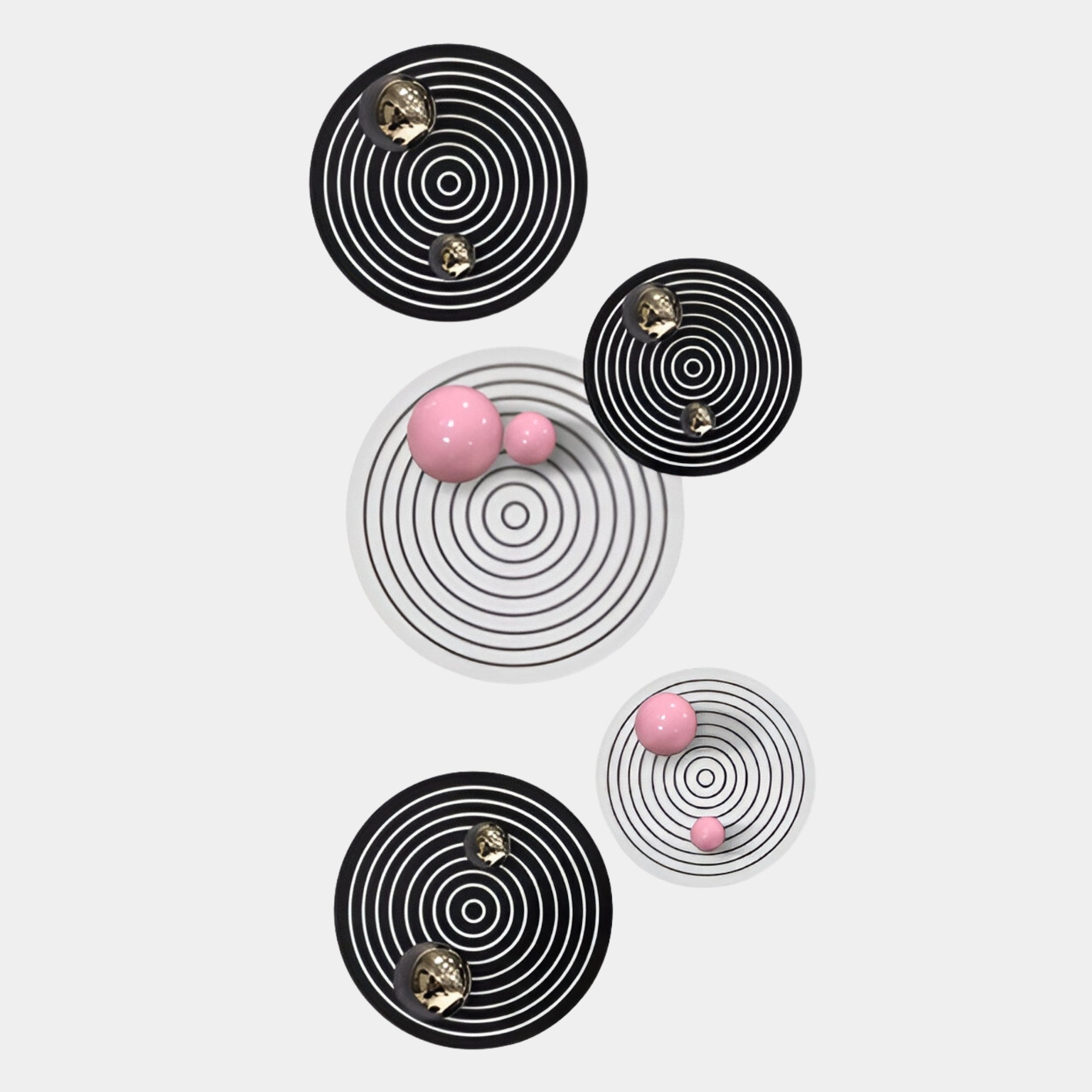 The Orbiora Pink & Gold Orb 5-Panel Concentric Sphere 3D Wall Art by Giant Sculptures features five circular panels with black, white, pink, and gold rings and spheres, creating a striking display on a plain white background.