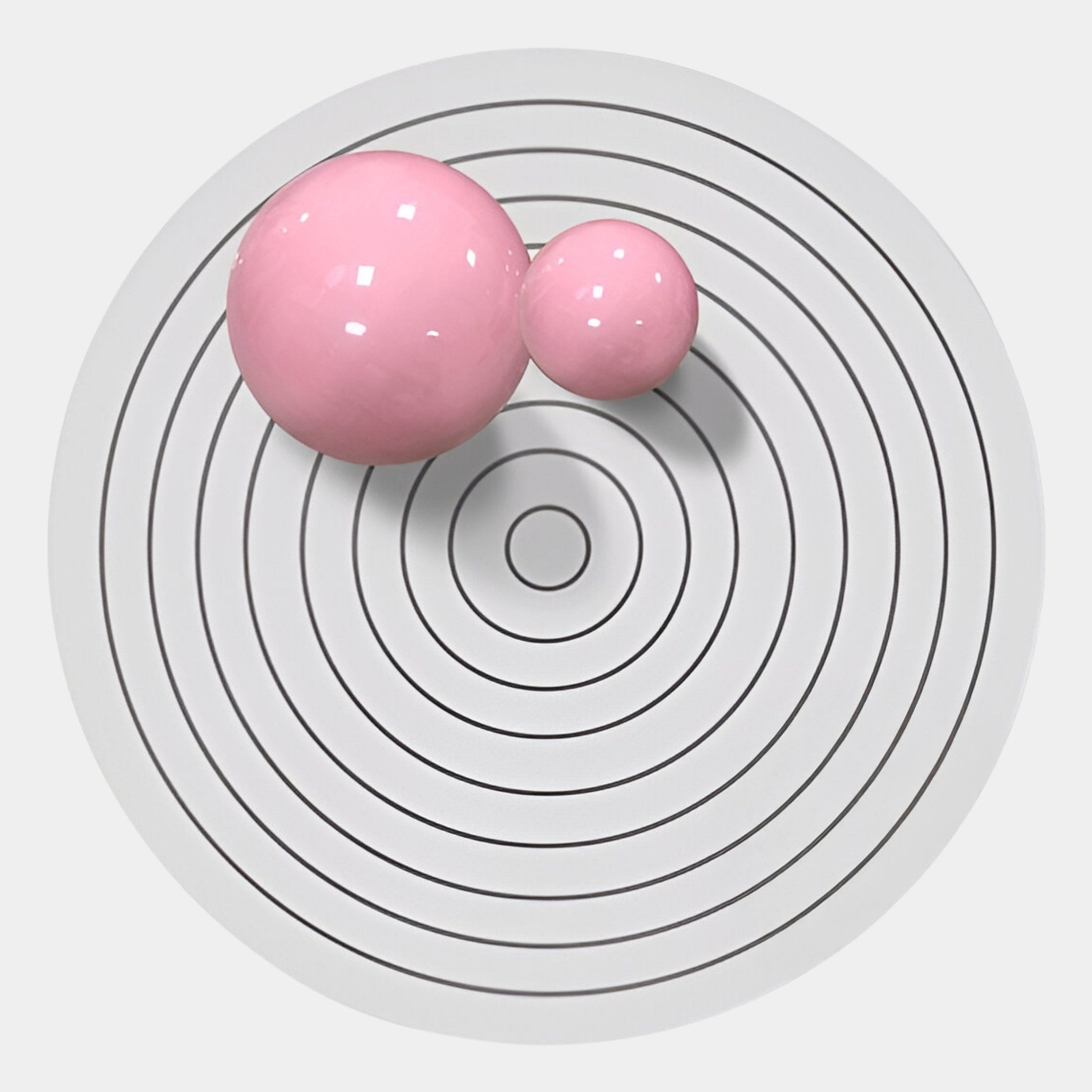 The Orbiora II Pink Duo Concentric Sphere 3D Wall Art by Giant Sculptures features two glossy pink spheres on a white surface with black concentric circles, offering a minimalist, modern touch ideal for contemporary wall decor.