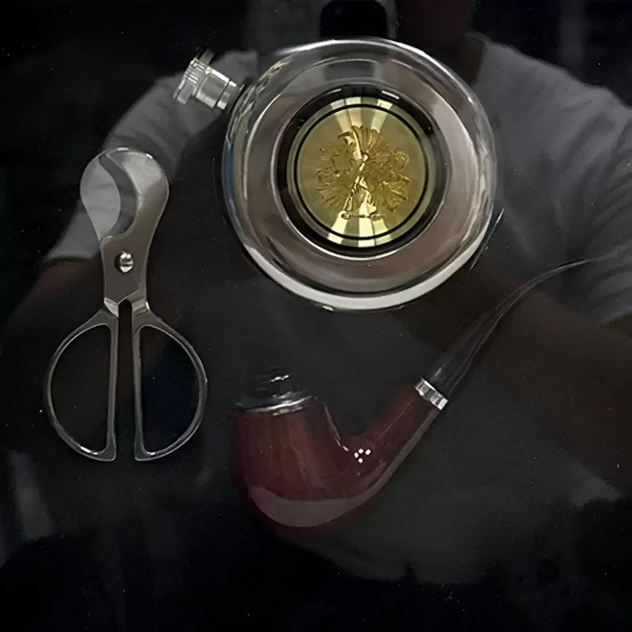 The Havantra Pipe & Scissors Smokers Set Framed Wall Art by Giant Sculptures features elegant vintage smoking accessories arranged on a dark reflective surface, perfect for sophisticated décor.