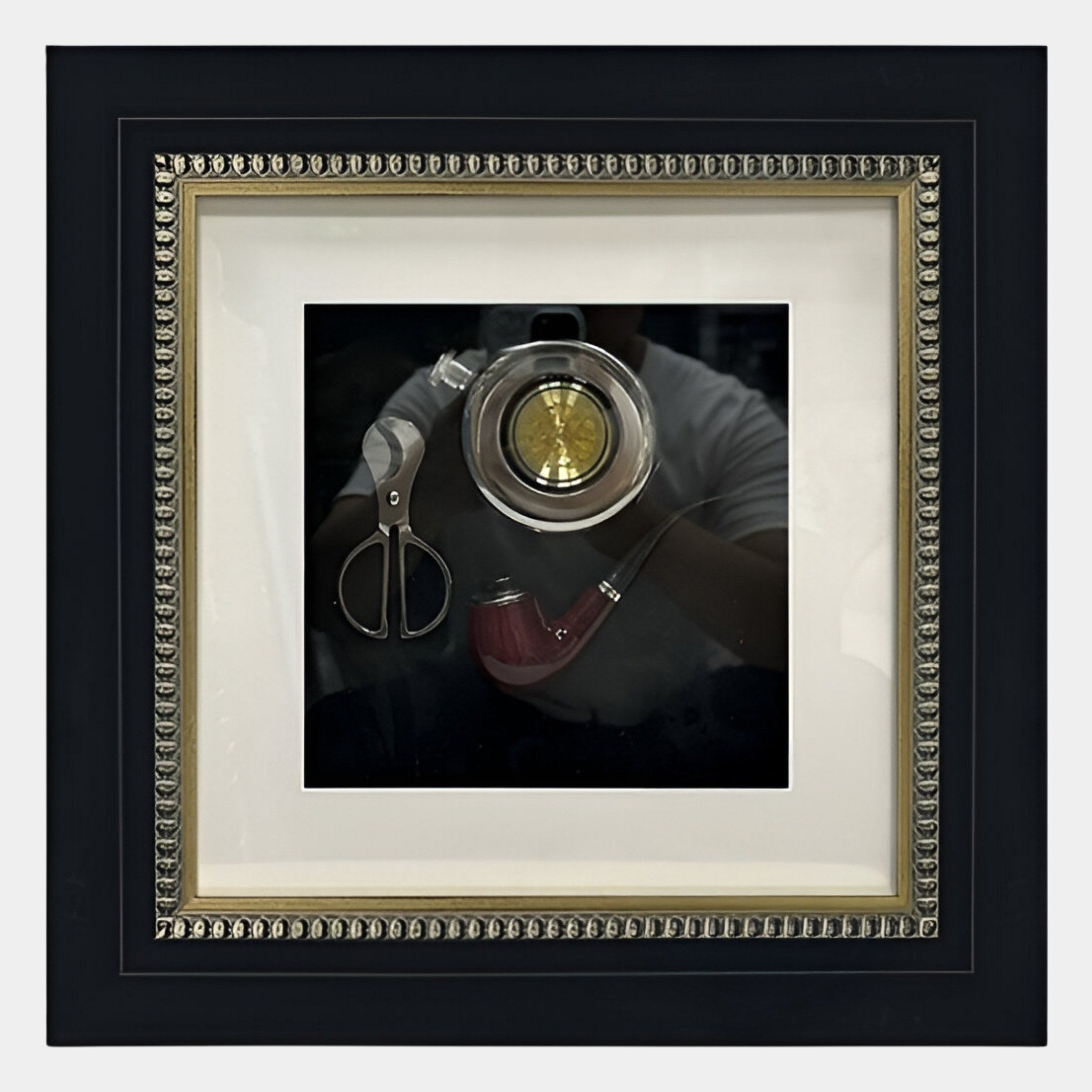 The Havantra Pipe & Scissors Smokers Set Framed Wall Art by Giant Sculptures showcases vintage smoking accessories on black with beaded trim. A faint reflection of a person appears in the glass.