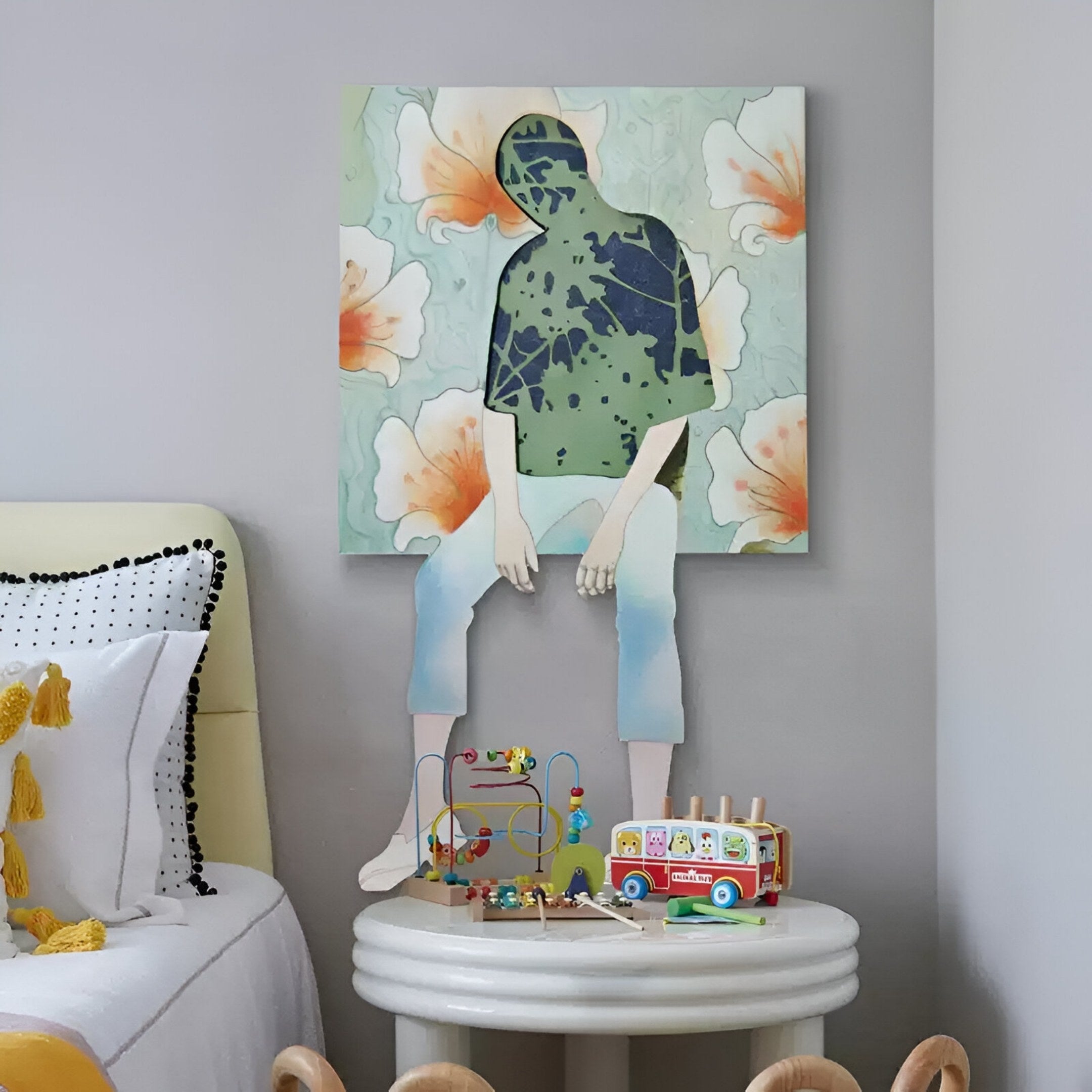 The Florivane Green Silhouette & Floral Backdrop 3D Wall Art by Giant Sculptures, featuring Nordic elegance, hangs above a small table with colorful toys beside a bed with a white and yellow pillow.