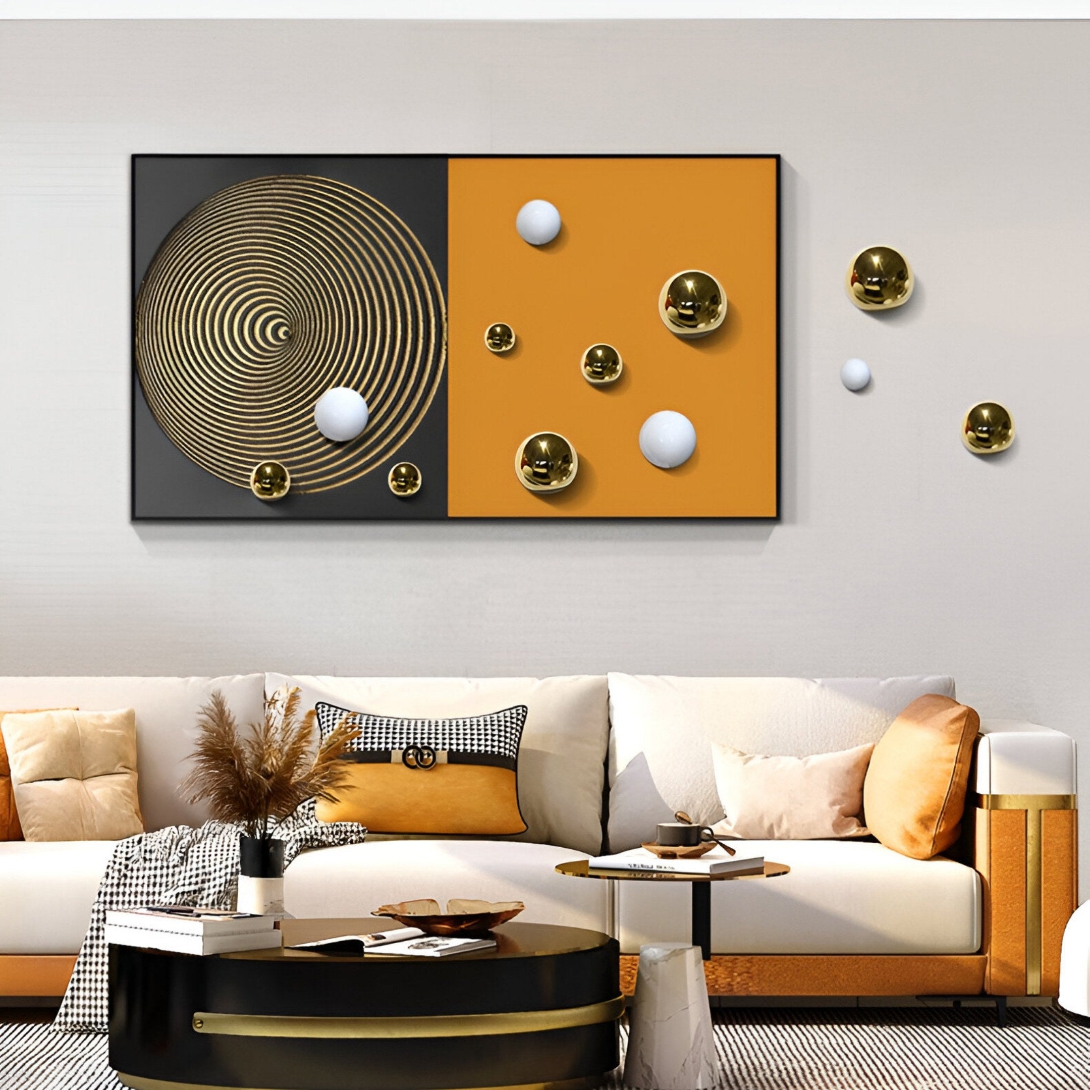 A modern living room with a white sofa, beige and gold pillows, a round coffee table, and Spherium Gold & White Orb Dual-Tone Panel 3D Wall Art by Giant Sculptures featuring concentric circles and floating spheres on black and gold panels.