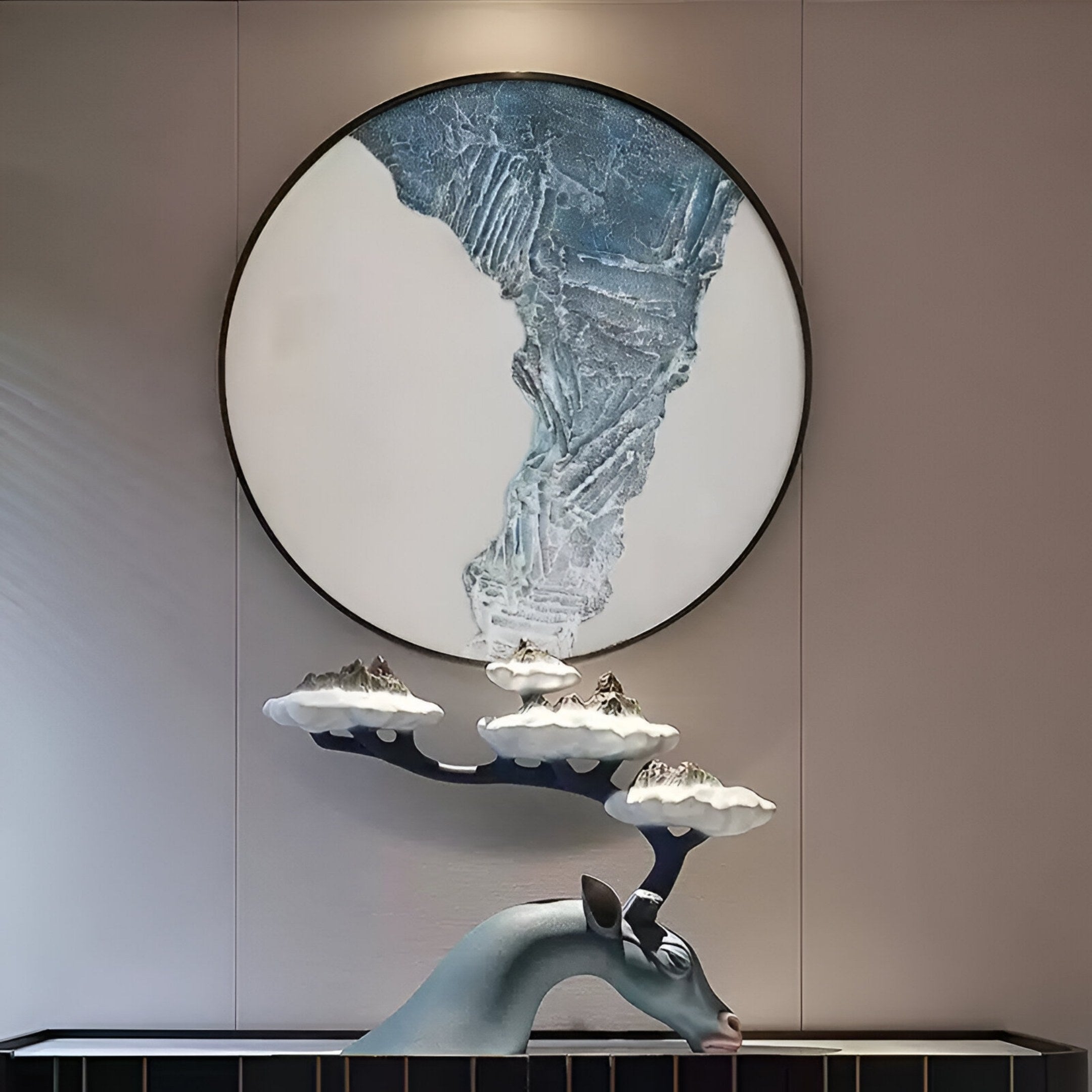 A blue deer sculpture with cloud and mountain antlers stands beneath the Giant Sculptures Cryora Blue Flow Textured Round 3D Wall Art, featuring blue and white tones, displayed on a beige wall.