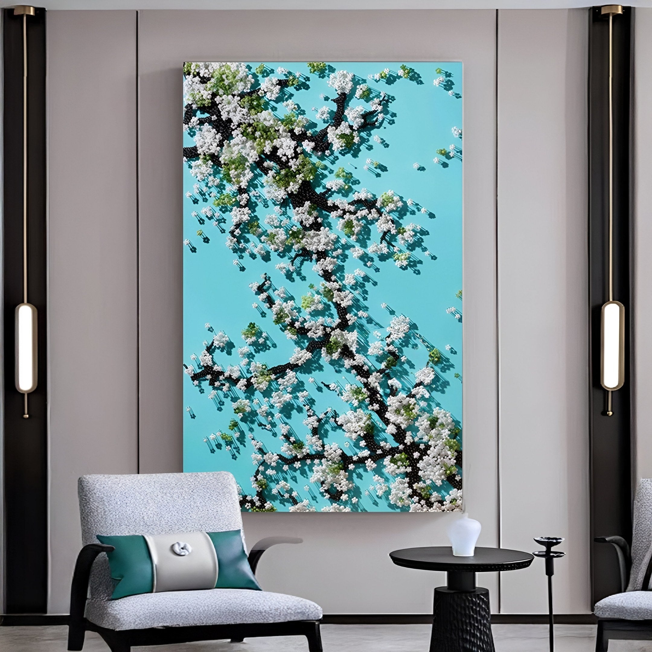 A modern living room showcases Giant Sculptures' Florivine Aqua Blossom Tree Button 3D Wall Art, featuring blossoming branches on a blue background, mounted on a gray wall between two cushioned armchairs and a small black round table.