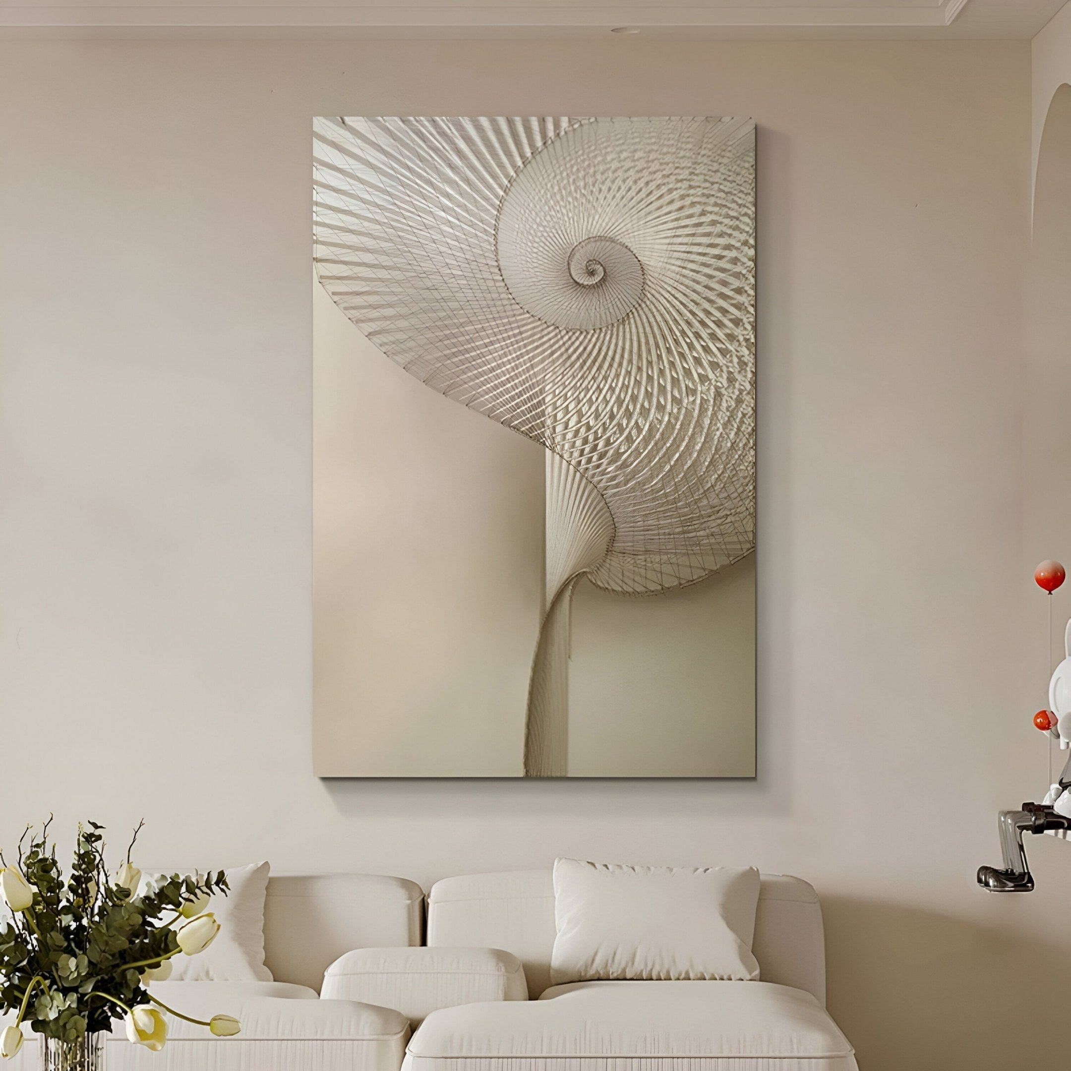 A modern living room with a white sofa, cushions, a small green plant on a table, and Giant Sculptures' Spiralis Natural String Abstract Lines Spiral 3D Wall Art in neutral tones as striking décor.