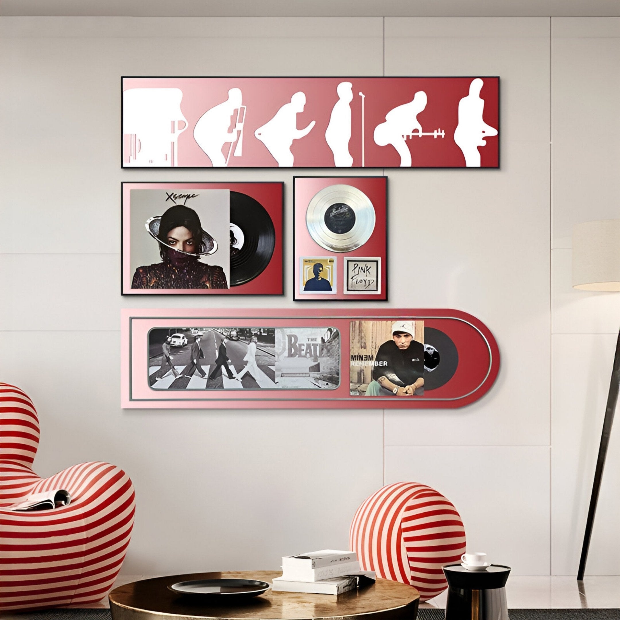 A modern living room features Giant Sculptures’ Sonarta Red Multi-Panel Record & Silhouette Wall Art, showcasing Beatles-inspired music decor and silhouettes. Red and white striped chairs are placed in the foreground.
