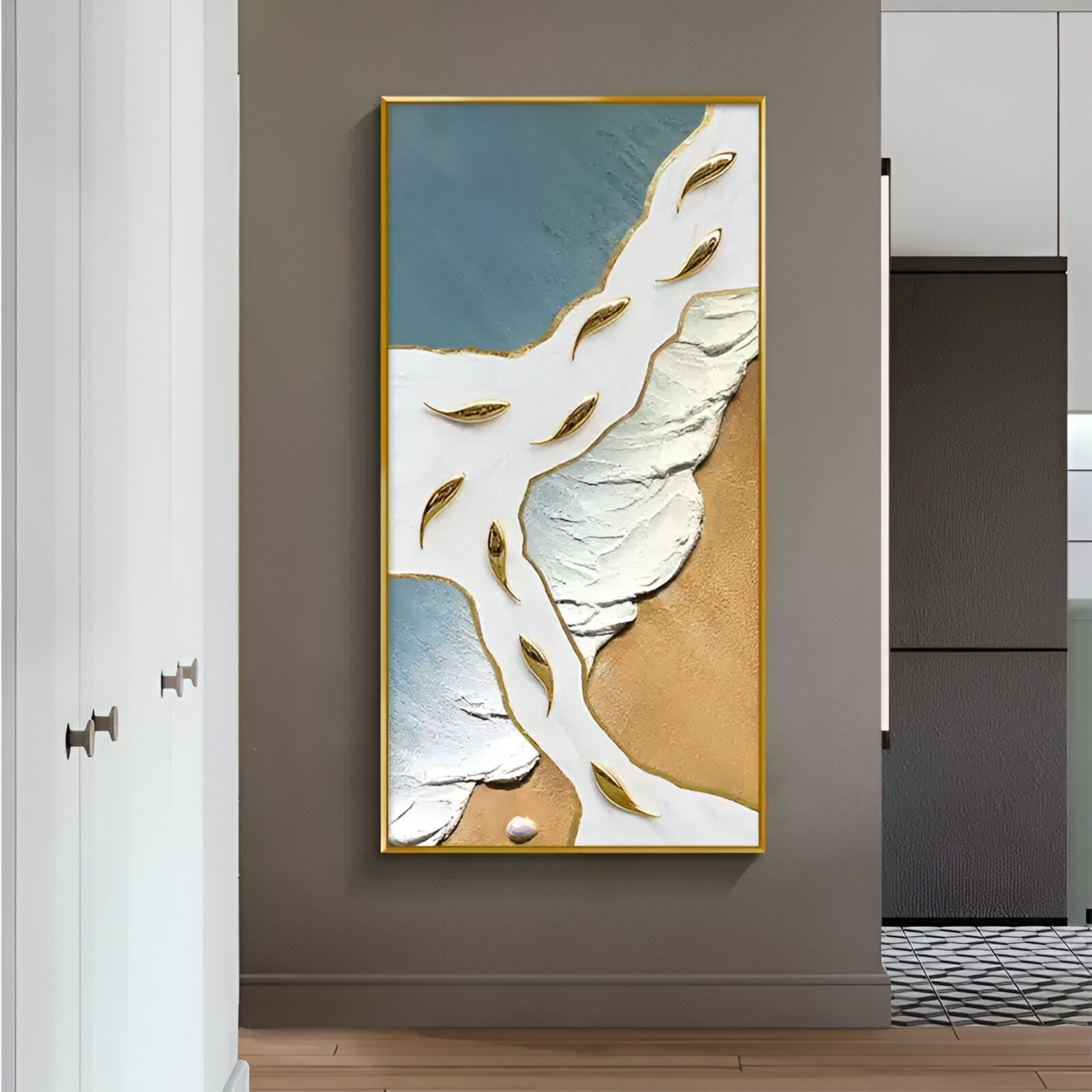 Pisaro Gold Fish Blue Shore & White Oil Canvas 3D Wall Art by Giant Sculptures features blue, white, and gold textures with gold fish shapes. Displayed on a gray hallway wall with light floors and white cabinets to the left.