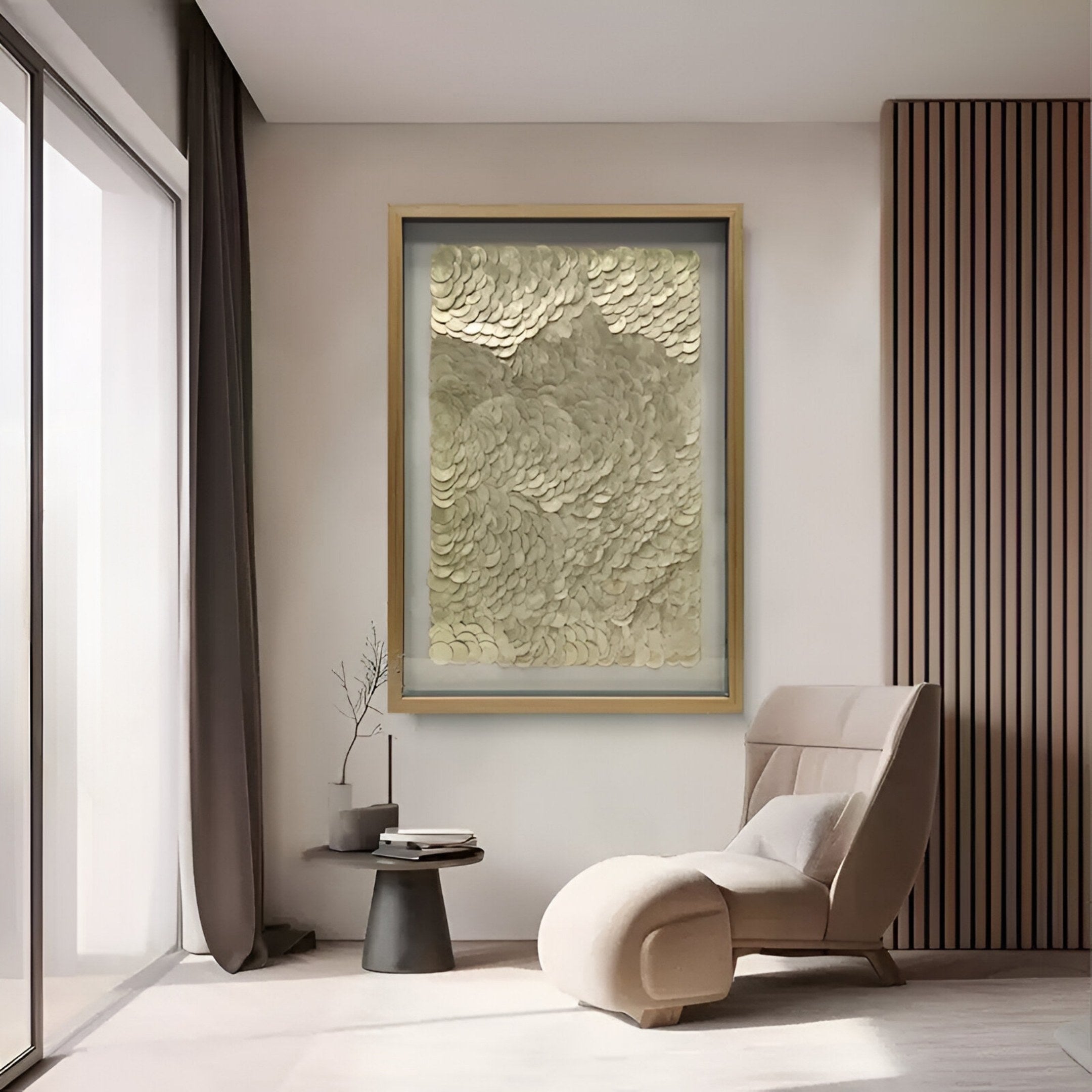 A modern, minimalist living room features a beige chaise lounge, small side table, and the Orraya Golden Shell Disc Layered Framed 3D Wall Art by Giant Sculptures above, positioned near a tall window with sheer curtains.