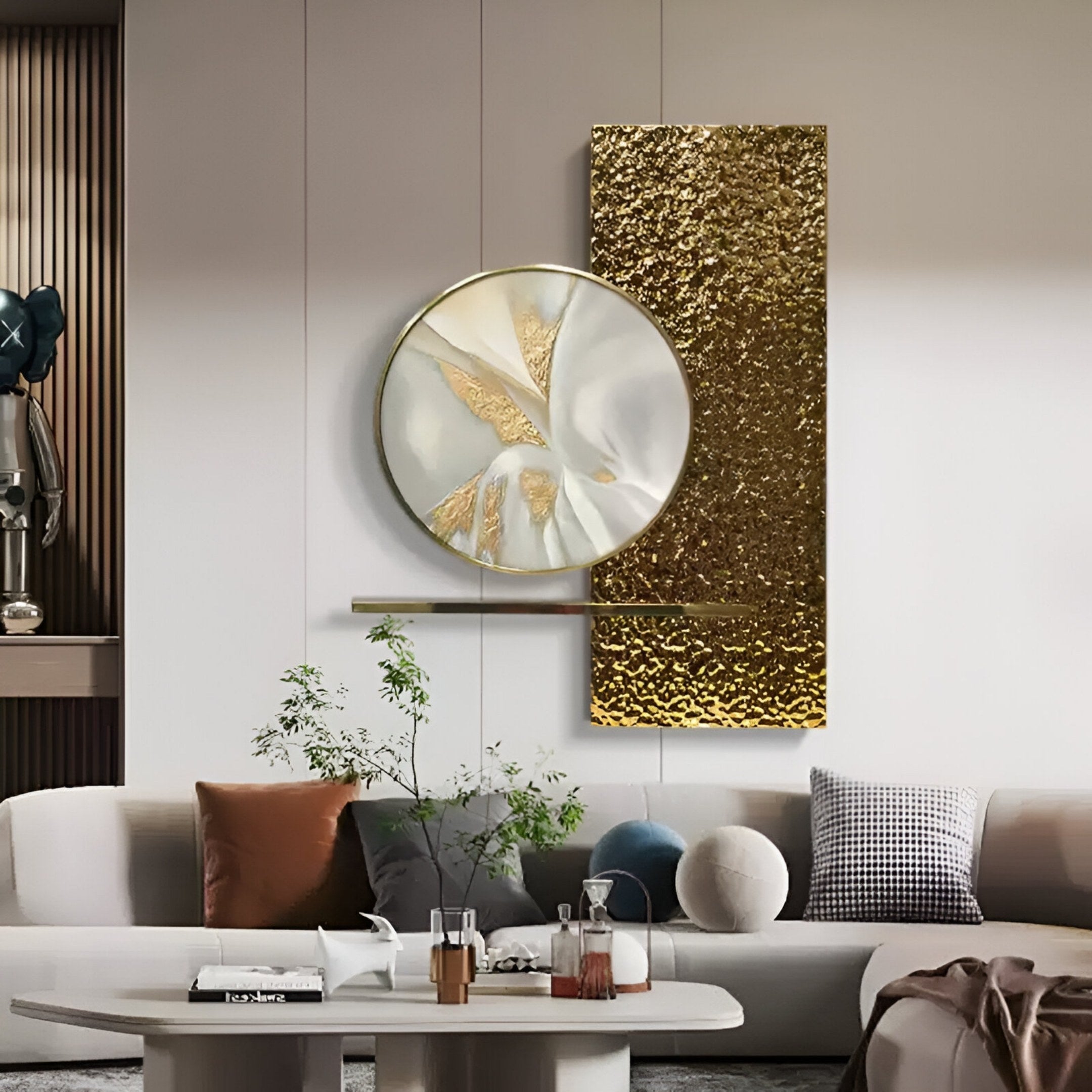 A modern living room features a white sofa, assorted cushions, a round coffee table with plants and decor, and the Giant Sculptures Aurivista White & Gold Abstract Circle Panel 3D Metal Wall Art on a crisp white wall.