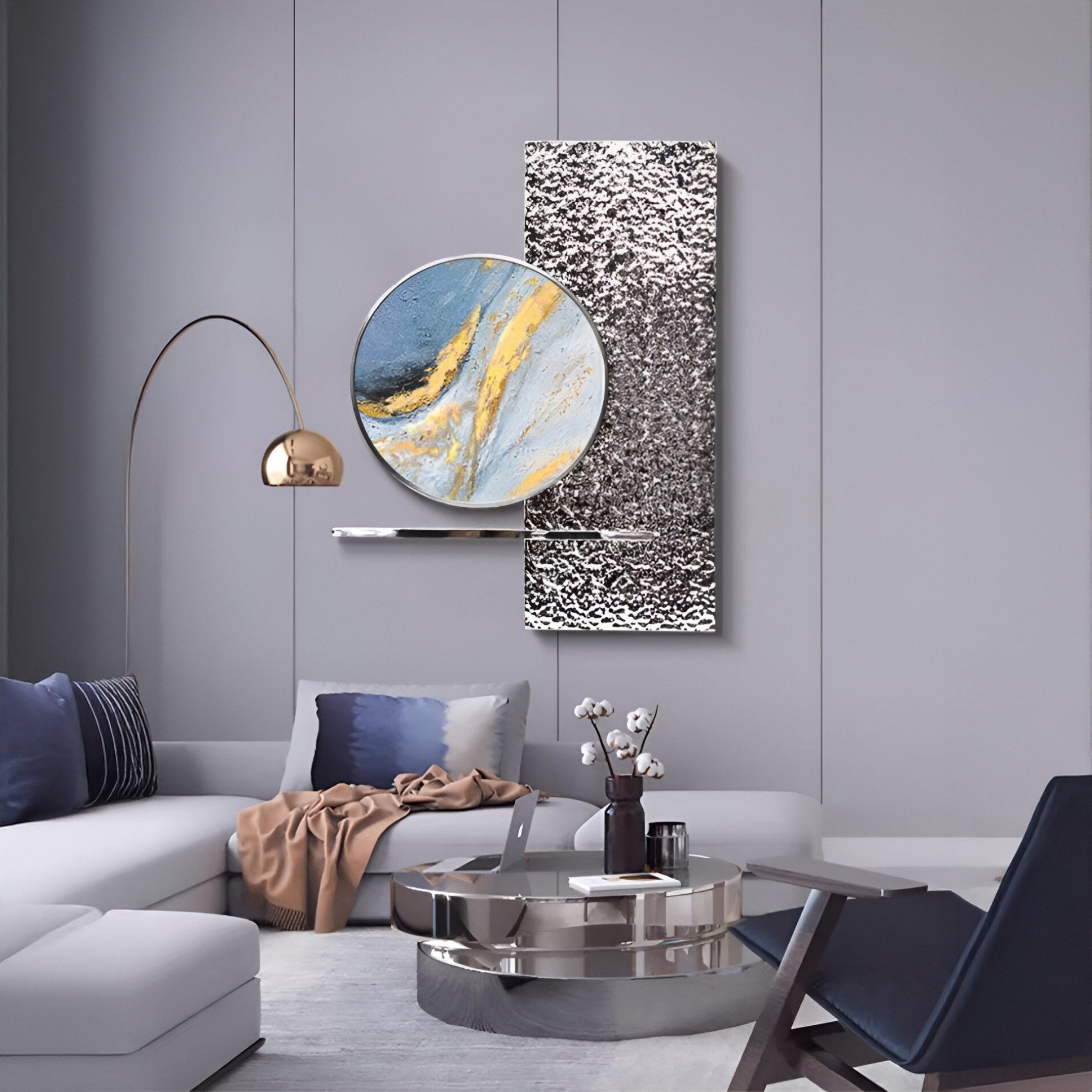 A modern living room with gray walls, Giant Sculptures’ Aurivista Blue & Silver Abstract Circle Panel 3D Metal Wall Art, abstract art, a round metallic coffee table, white sectional with pillows, beige throw, gold-shade floor lamp, and dark accent chair.