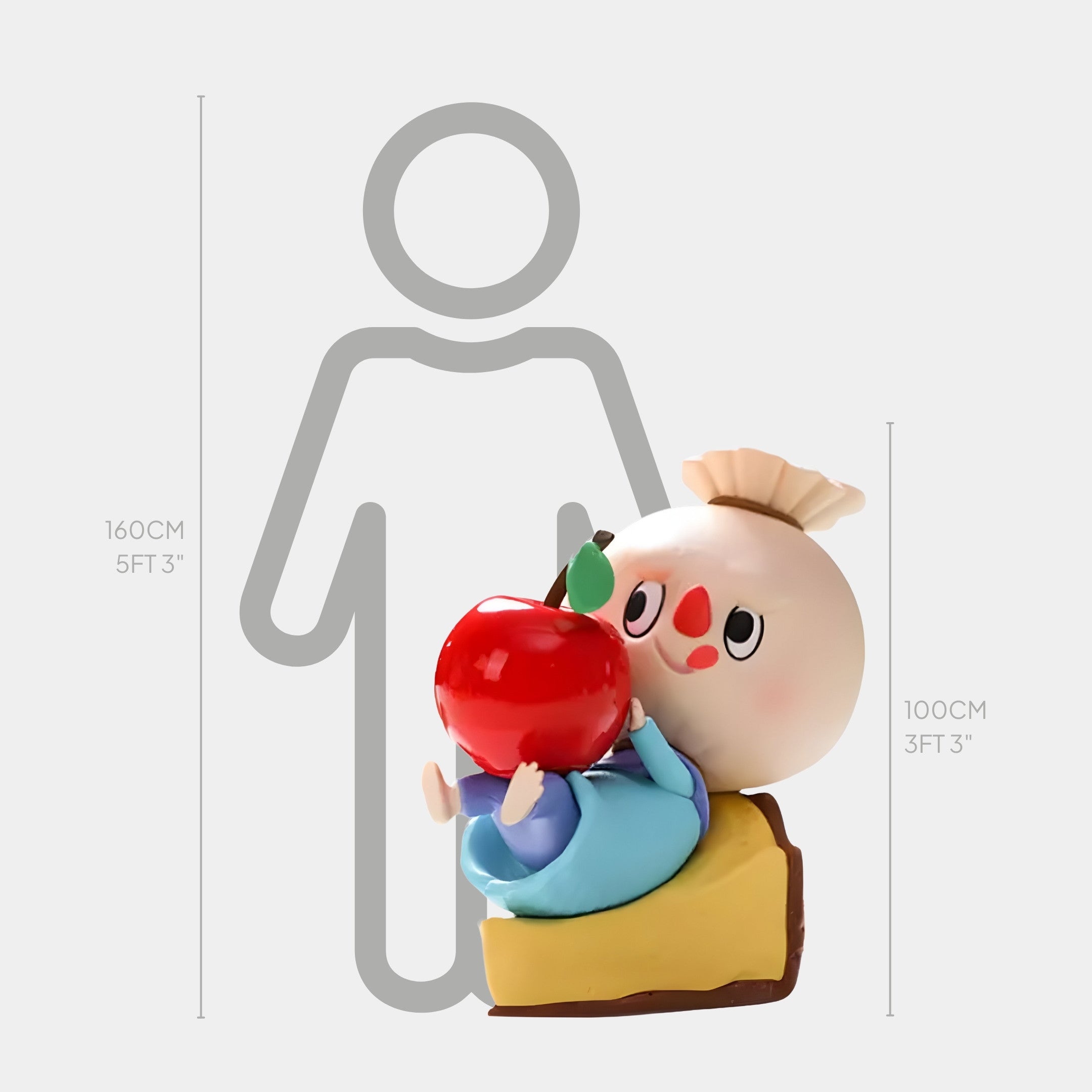 A whimsical indoor display presents the Giant Sculptures Sweet Mischief Apple Pie Labubu Sculpture - 100cm, a round-faced character with a red apple sitting on cake, shown beside a height chart comparing its size to an adult silhouette.