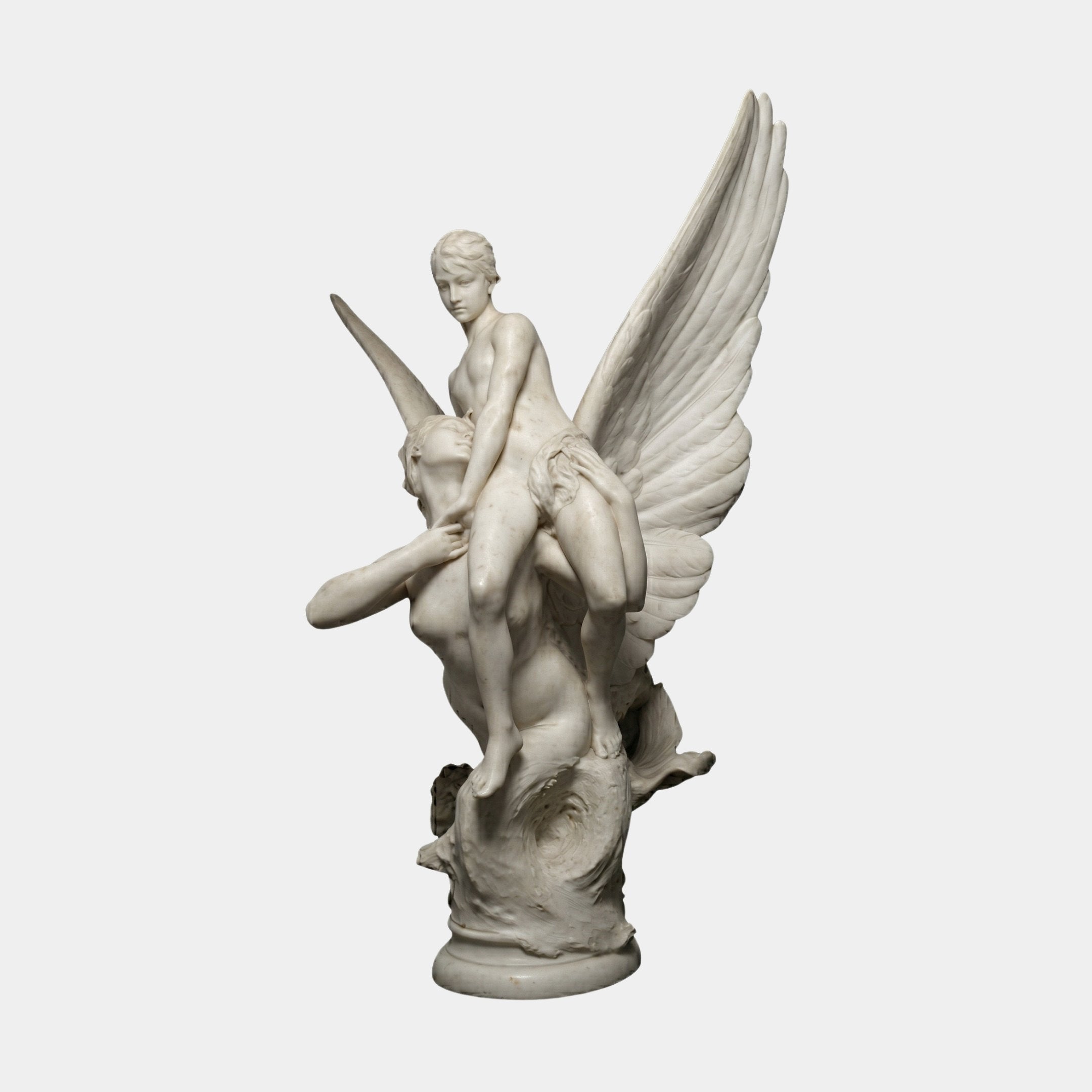 Winged Siren Angel Marble Outdoor Sculpture in natural white marble, depicting two intertwined figures with dramatic outstretched wings on a circular base, shown against a plain light background.