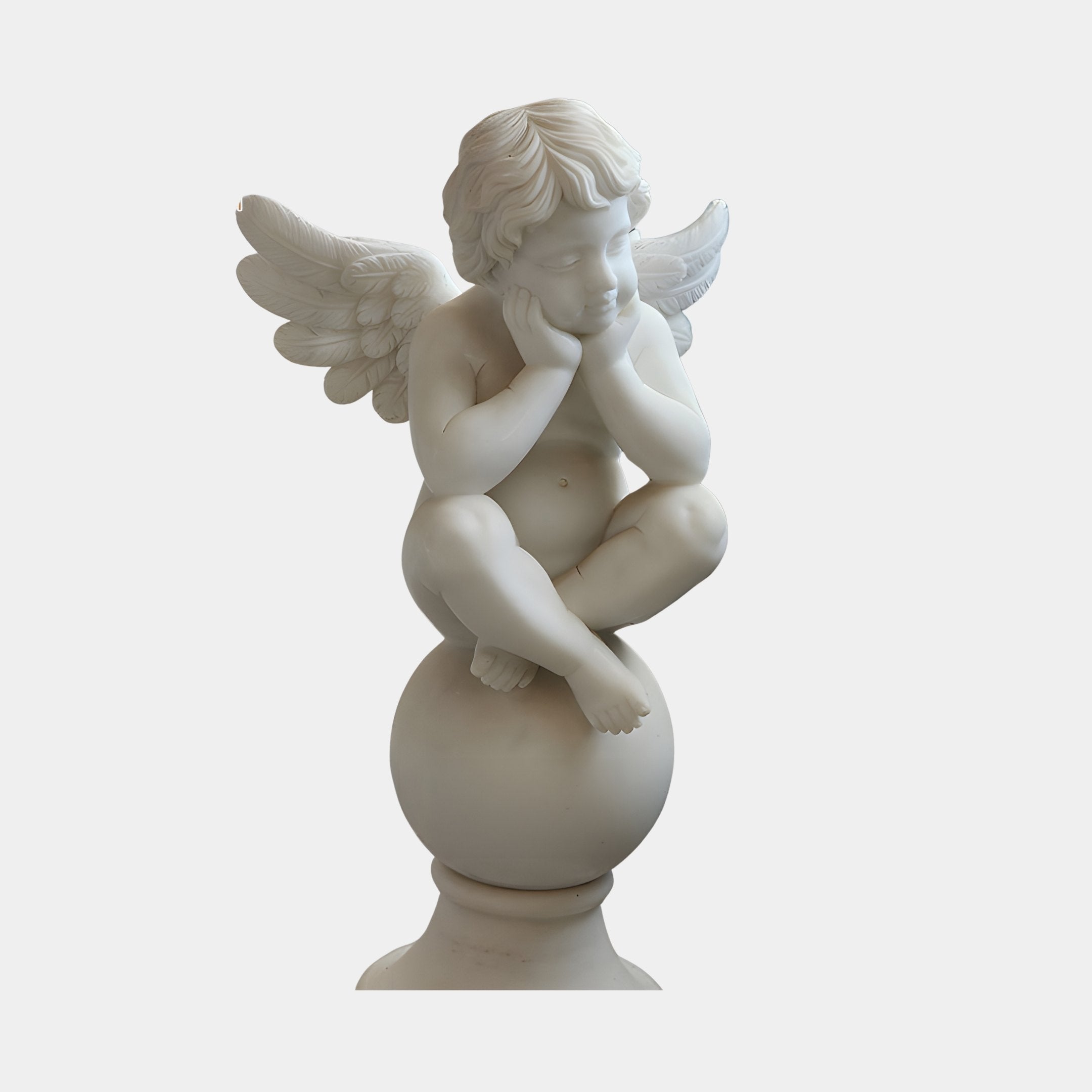 Cherub V5 Angel Marble Outdoor Sculpture by Giant Sculptures, a hand-carved white marble winged cherub sitting cross-legged on a sphere, 80cm tall, on a plain light background.