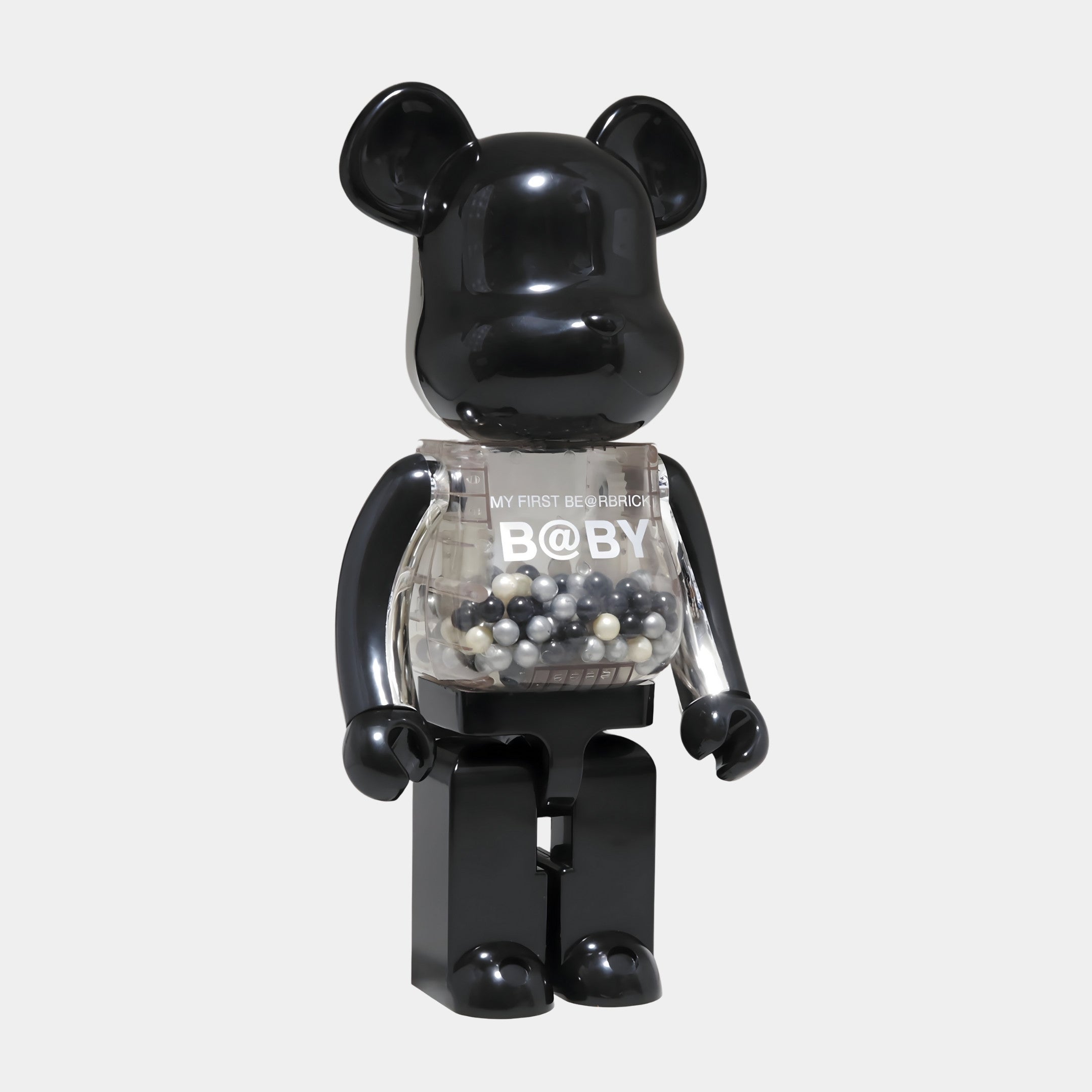 The Midnight Chrome Beads Bear Sculpture (70cm) by Giant Sculptures features a sleek black resin bear with a clear torso filled with chrome beads in black, white, and gray—ideal for enhancing modern interiors.