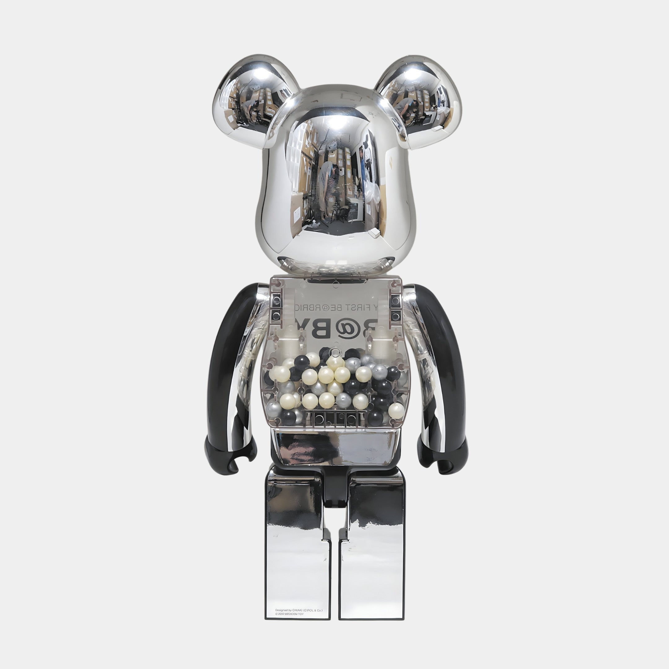 The Midnight Chrome Beads Bear Sculpture - 70cm by Giant Sculptures features metallic silver, black resin arms, and a transparent chest with white and black spheres—an eye-catching accent for modern interiors.