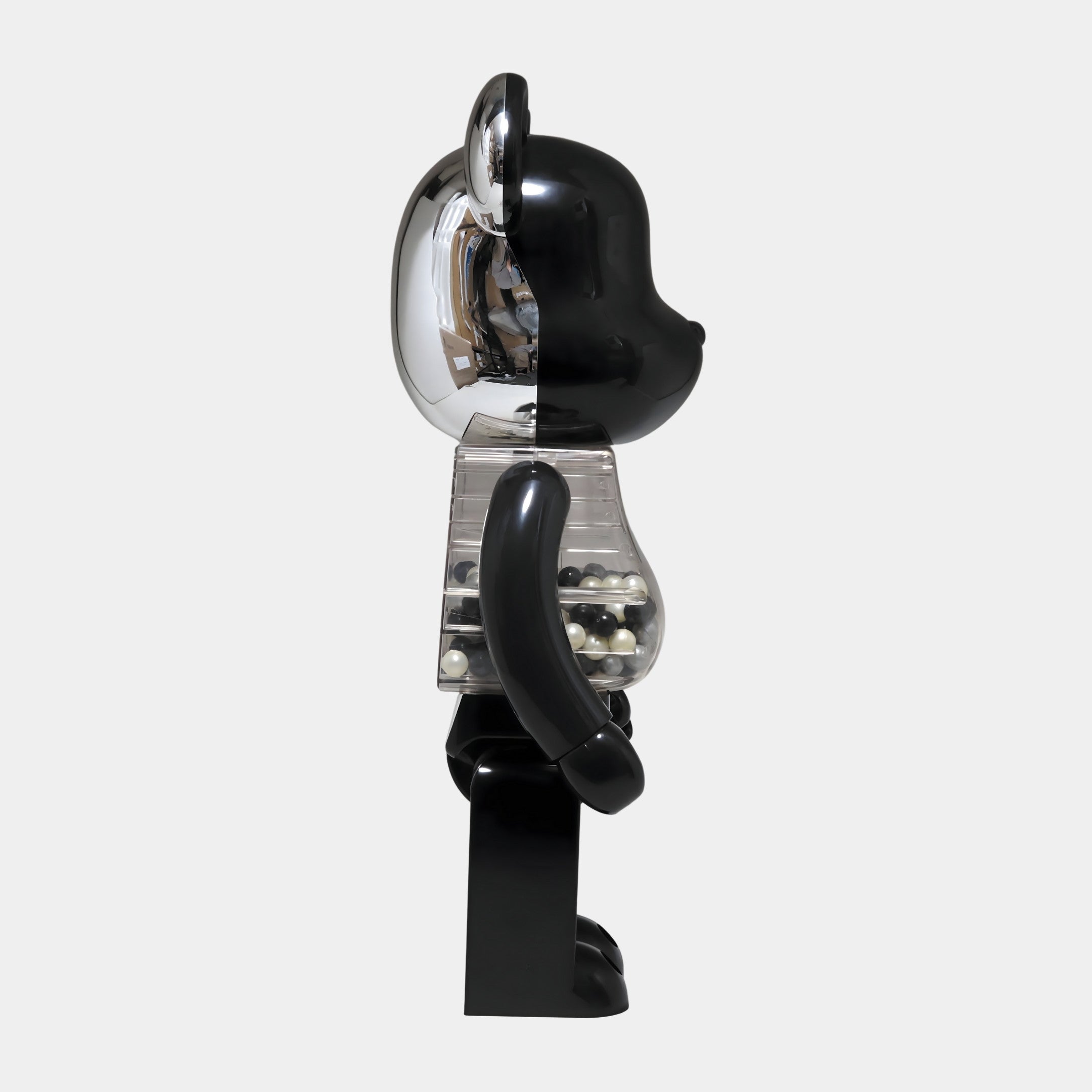 The Giant Sculptures Midnight Chrome Beads Bear Sculpture - 70cm displays a shiny silver head and transparent midsection with midnight chrome beads, creating a striking modern accent for any contemporary interior.