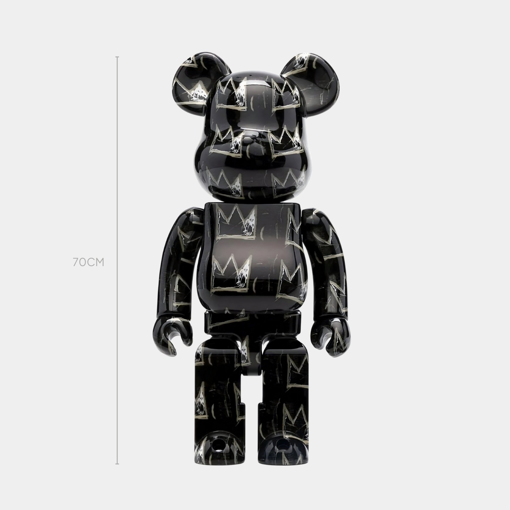 The Giant Sculptures Midnight Crown Bear Sculpture - 70cm features a shiny finish and Basquiat-inspired white crown graffiti, standing upright against a plain light background.