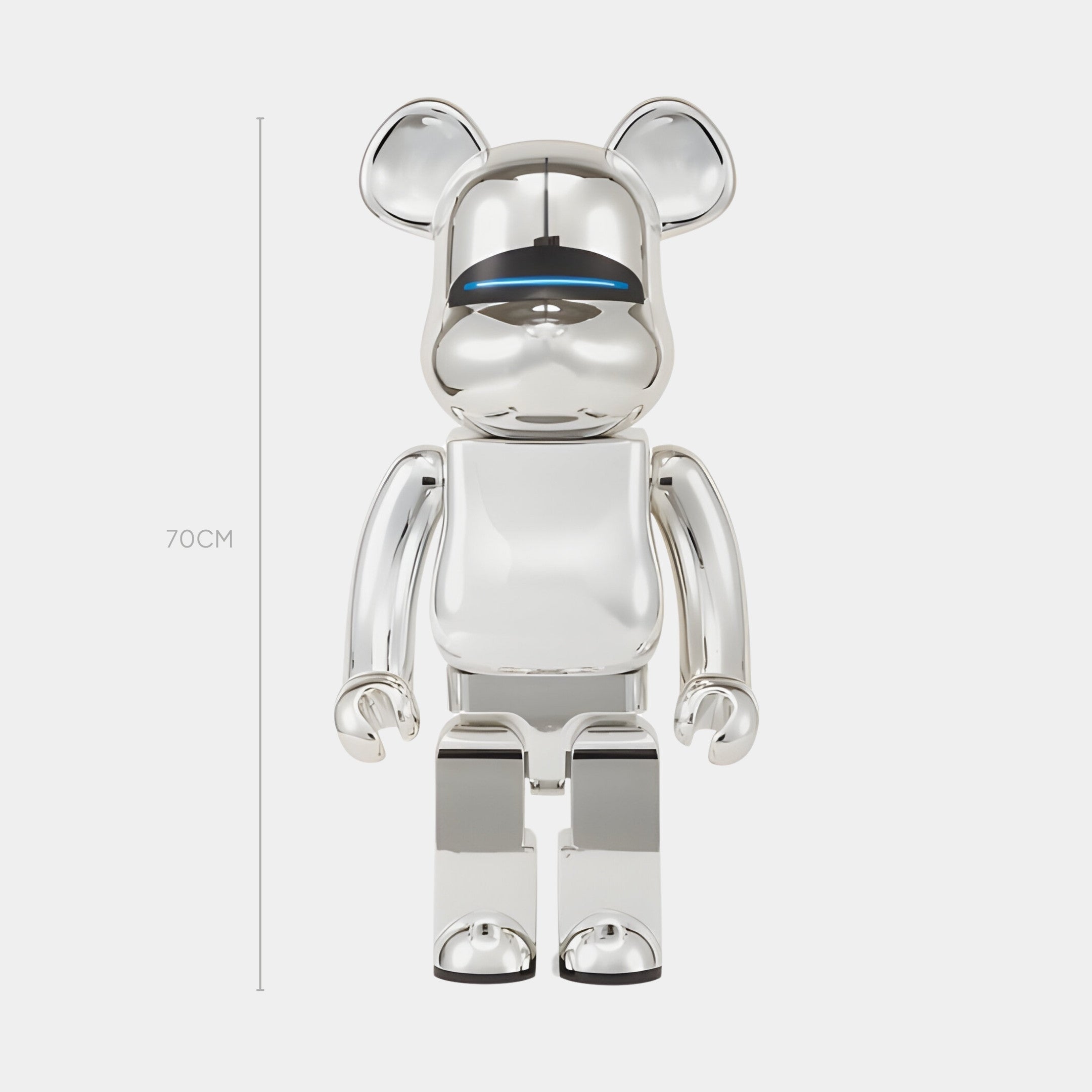 The Mirror Chrome Bear Sculpture - 70cm by Giant Sculptures is a shiny, silver piece with rounded ears, a visor-like blue line across its face, and a reflective surface that highlights sleek, modern artistry.