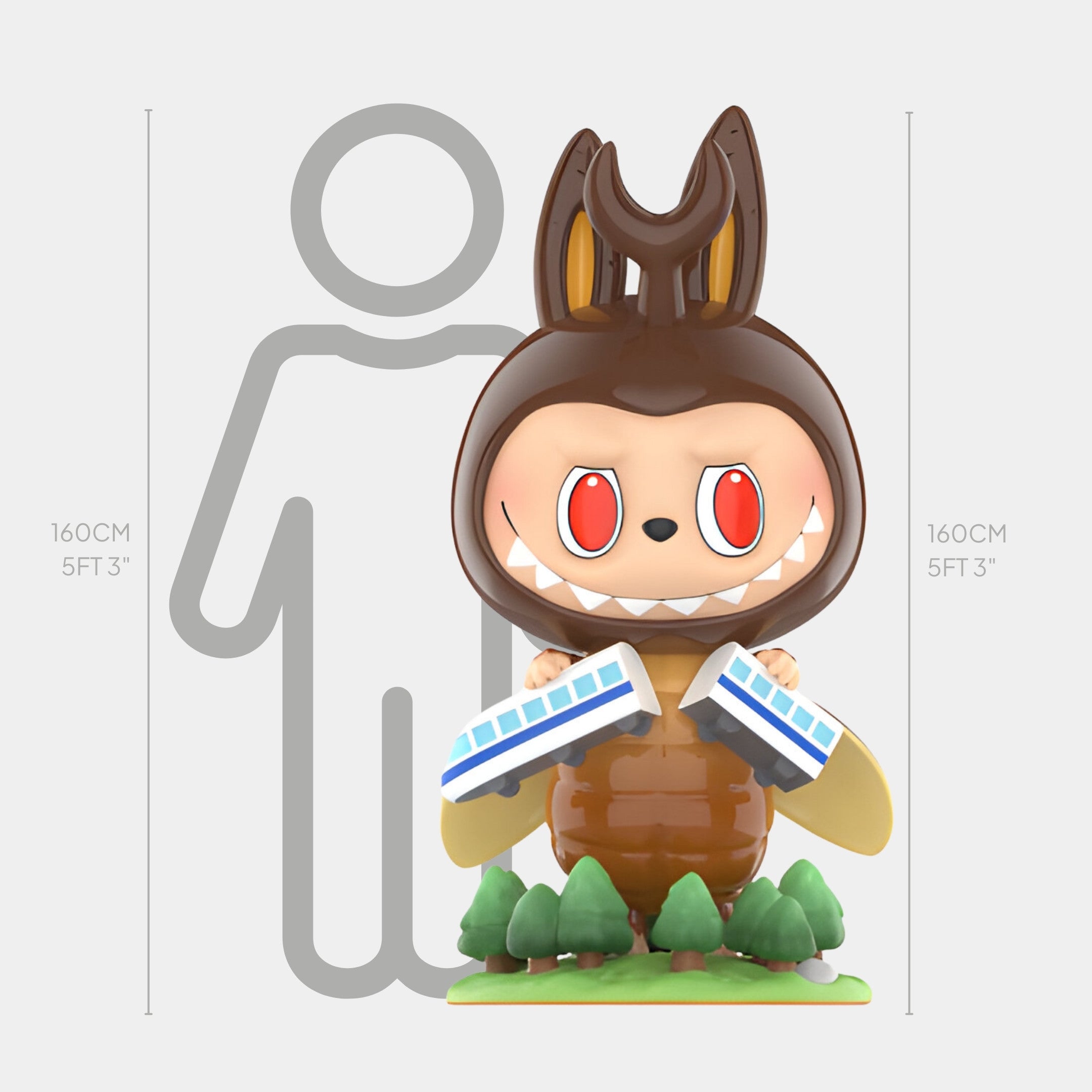 The Monsterverse Bug Labubu Sculpture by Giant Sculptures stands 160cm tall, featuring red eyes, bunny ears, and sharp teeth, holding two blue-and-white trains above small trees and a human silhouette.