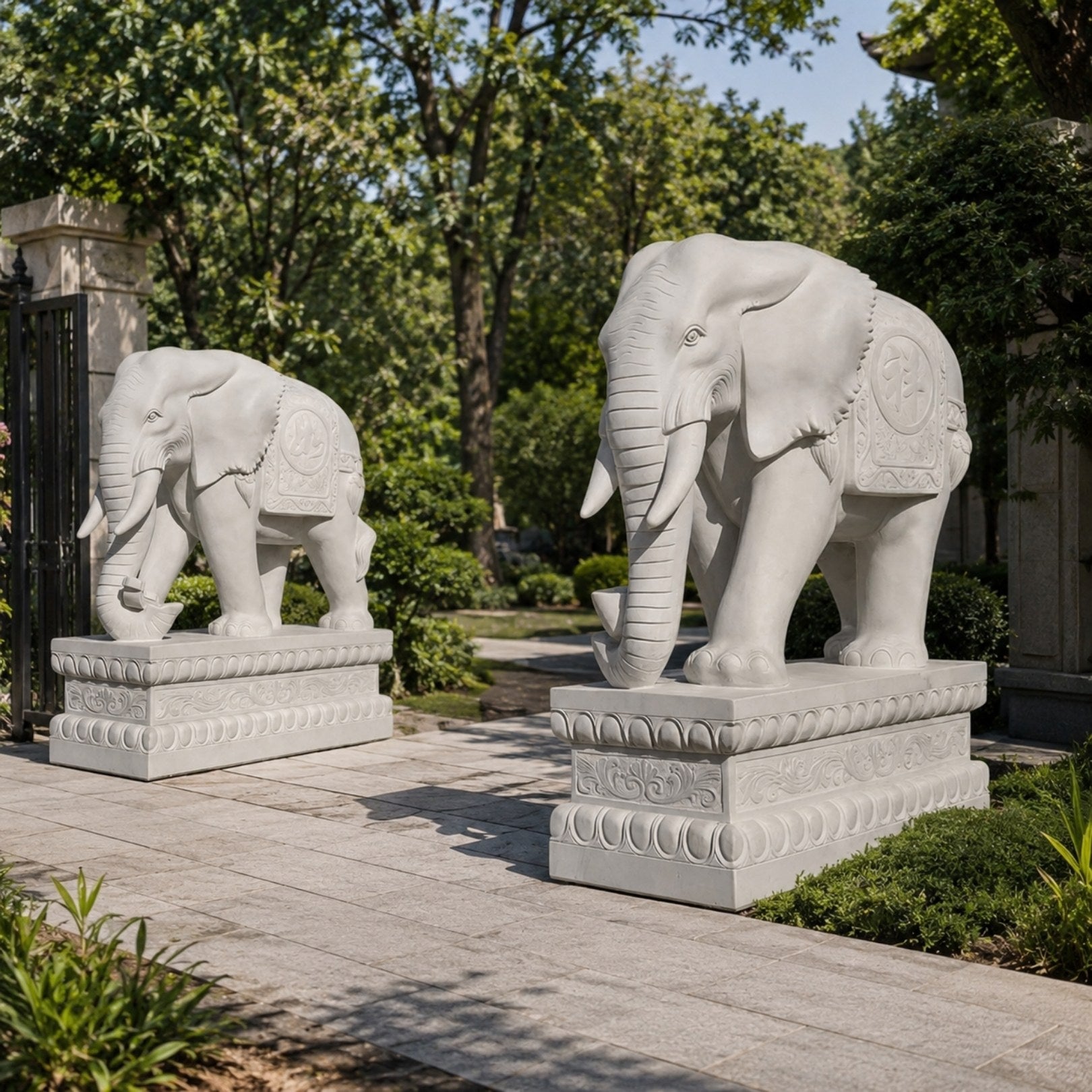 Brilliant white marble elephant with its trunk curled down holding an ingot