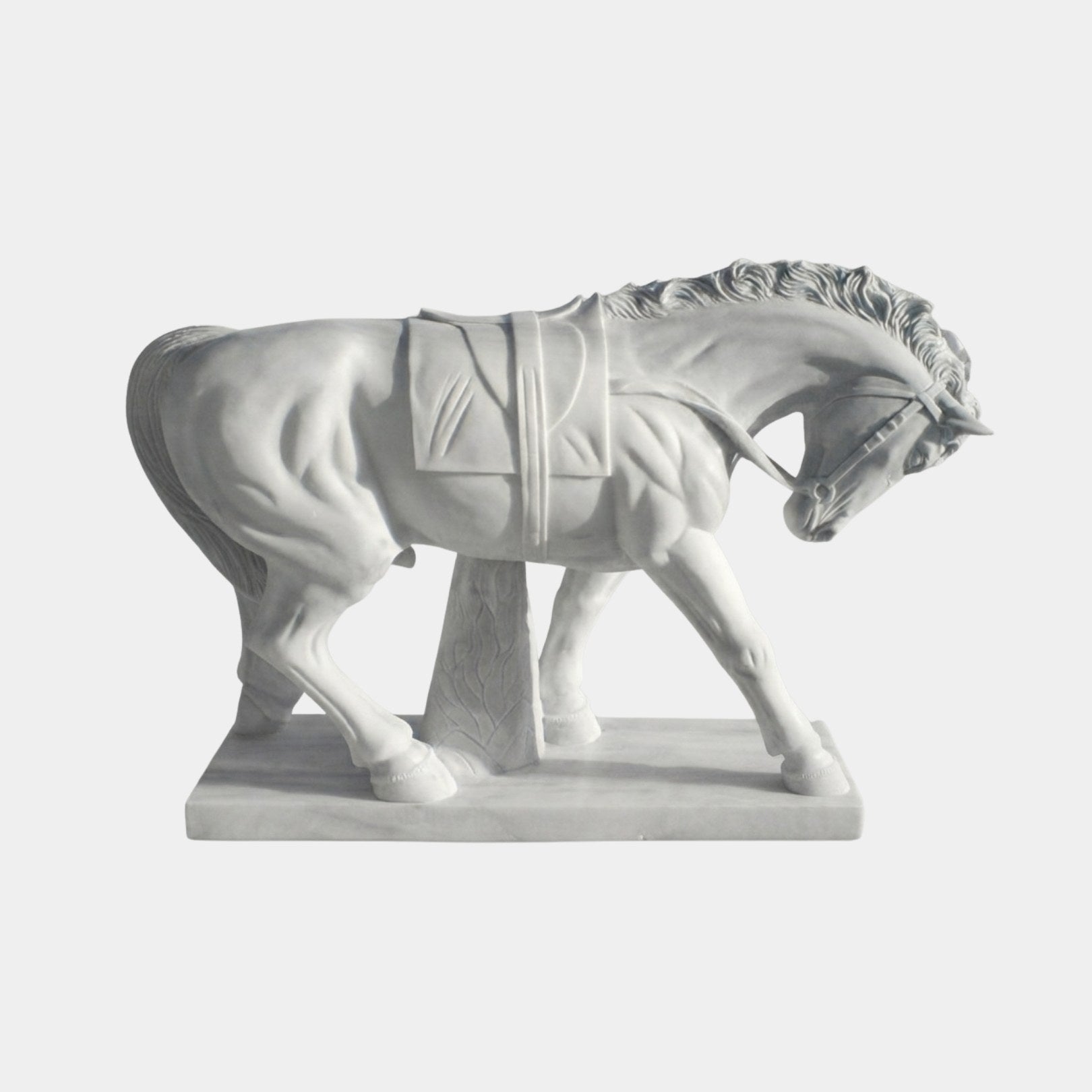 White marble horse with head lowered, wearing a bridle and girthed saddle