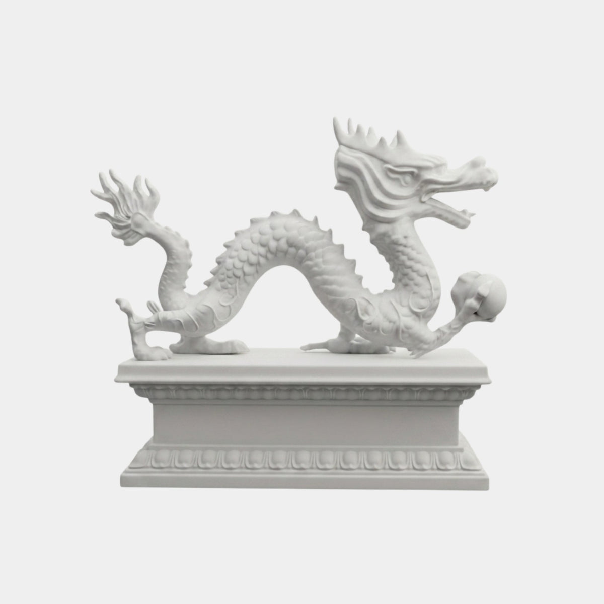 White marble Chinese dragon walking with its back arched and a sphere in one claw