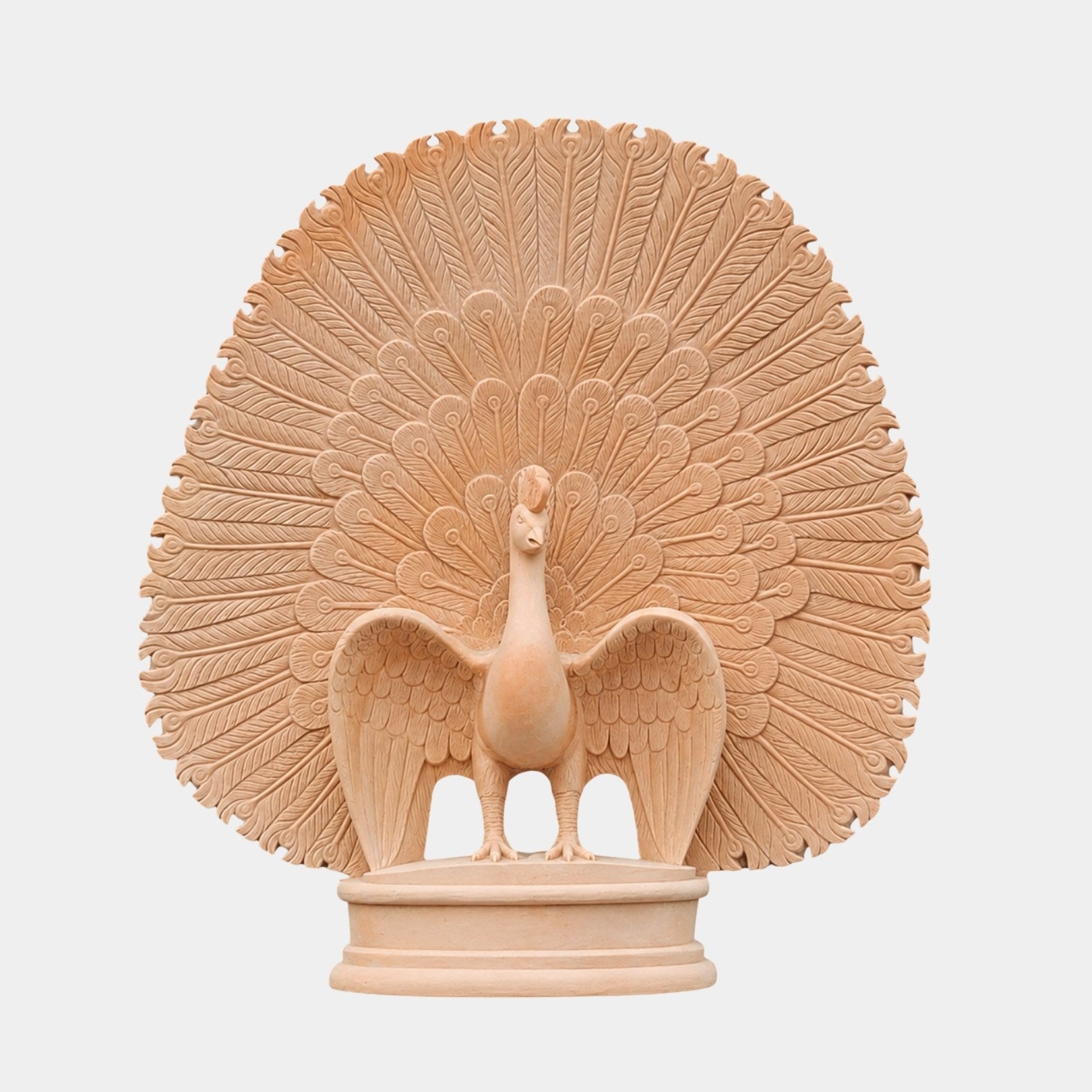 Peach-apricot marble peacock with its tail fully displayed as a carved screen