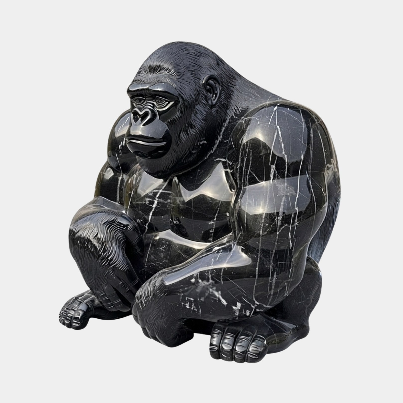 Black marble gorilla seated forward on its knuckles with bold white veining
