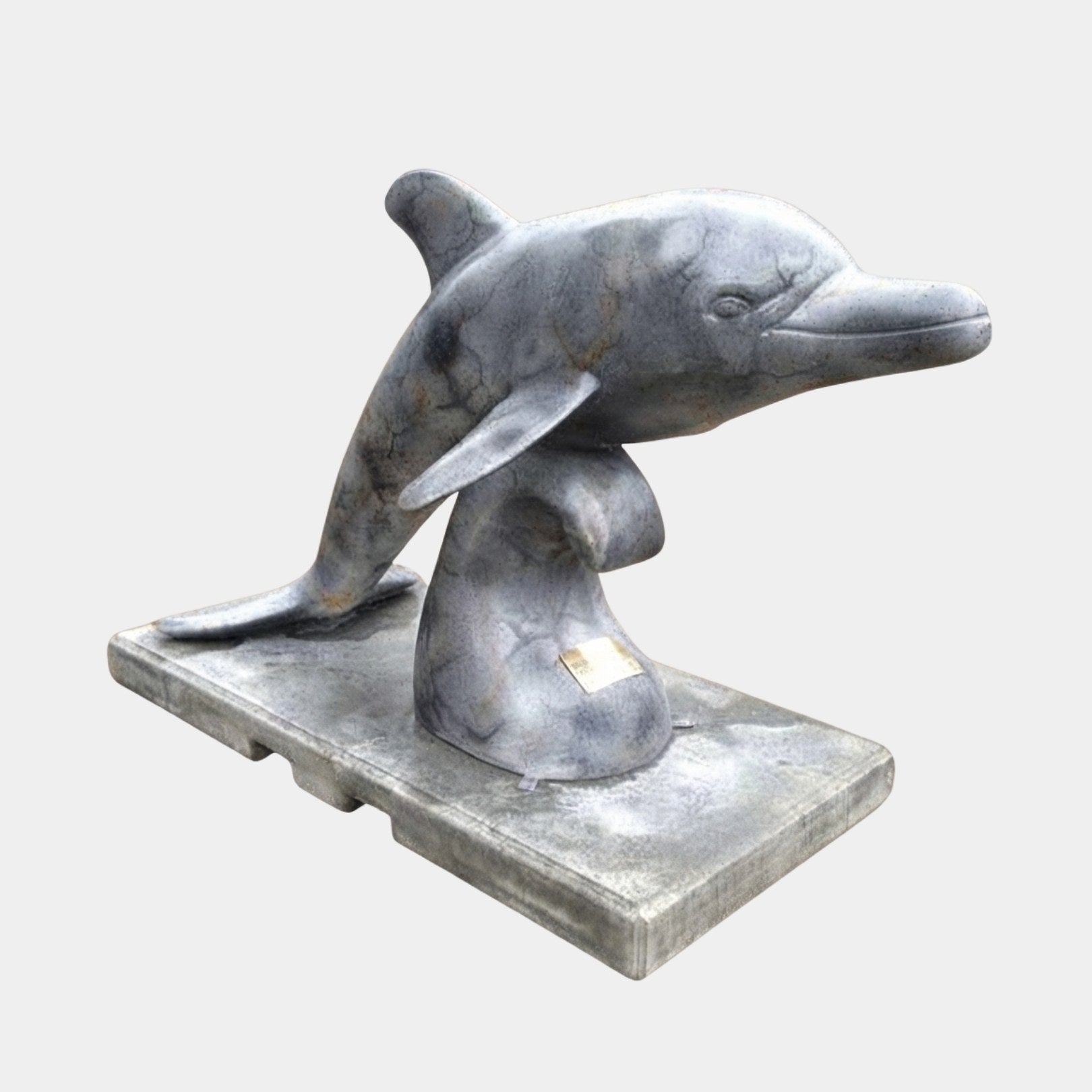 Grey marble dolphin arching clear of the water on a tapered support