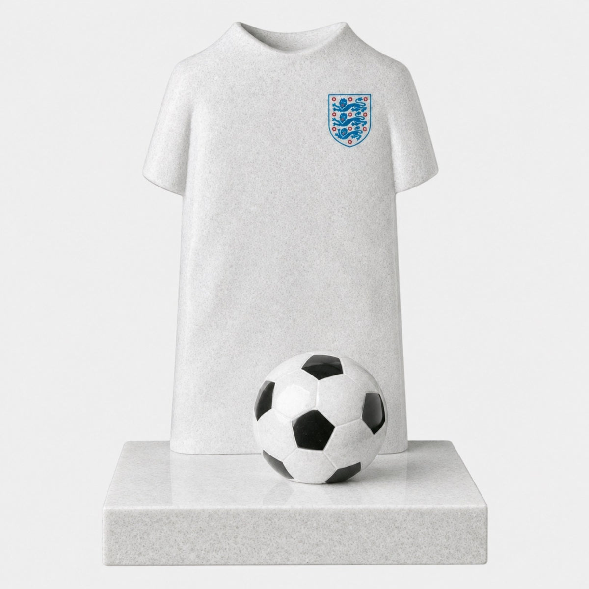 Pale white and grey stone child memorial carved as a football shirt with a ball, 120cm