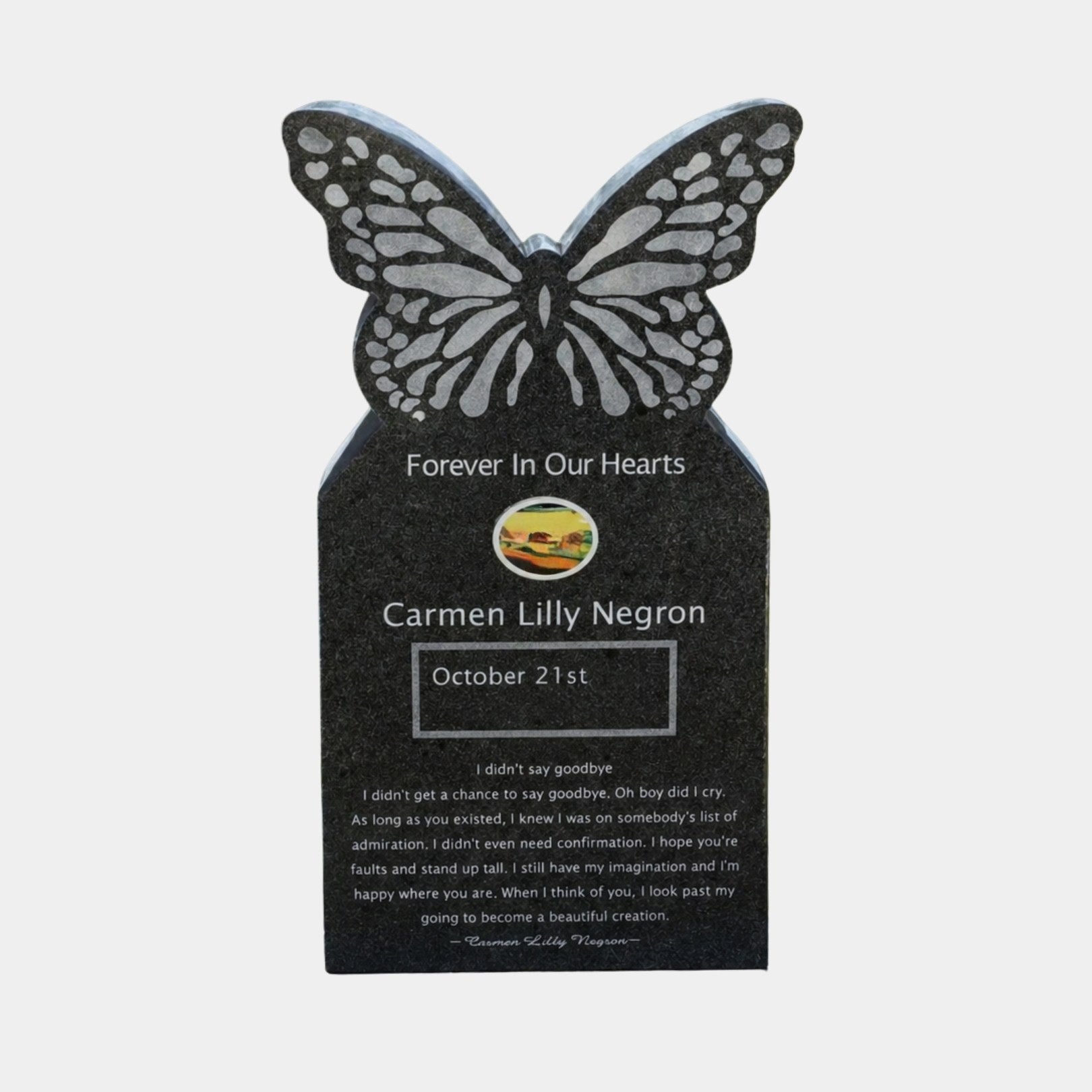 Black granite butterfly headstone with frosted wing cells on a tablet